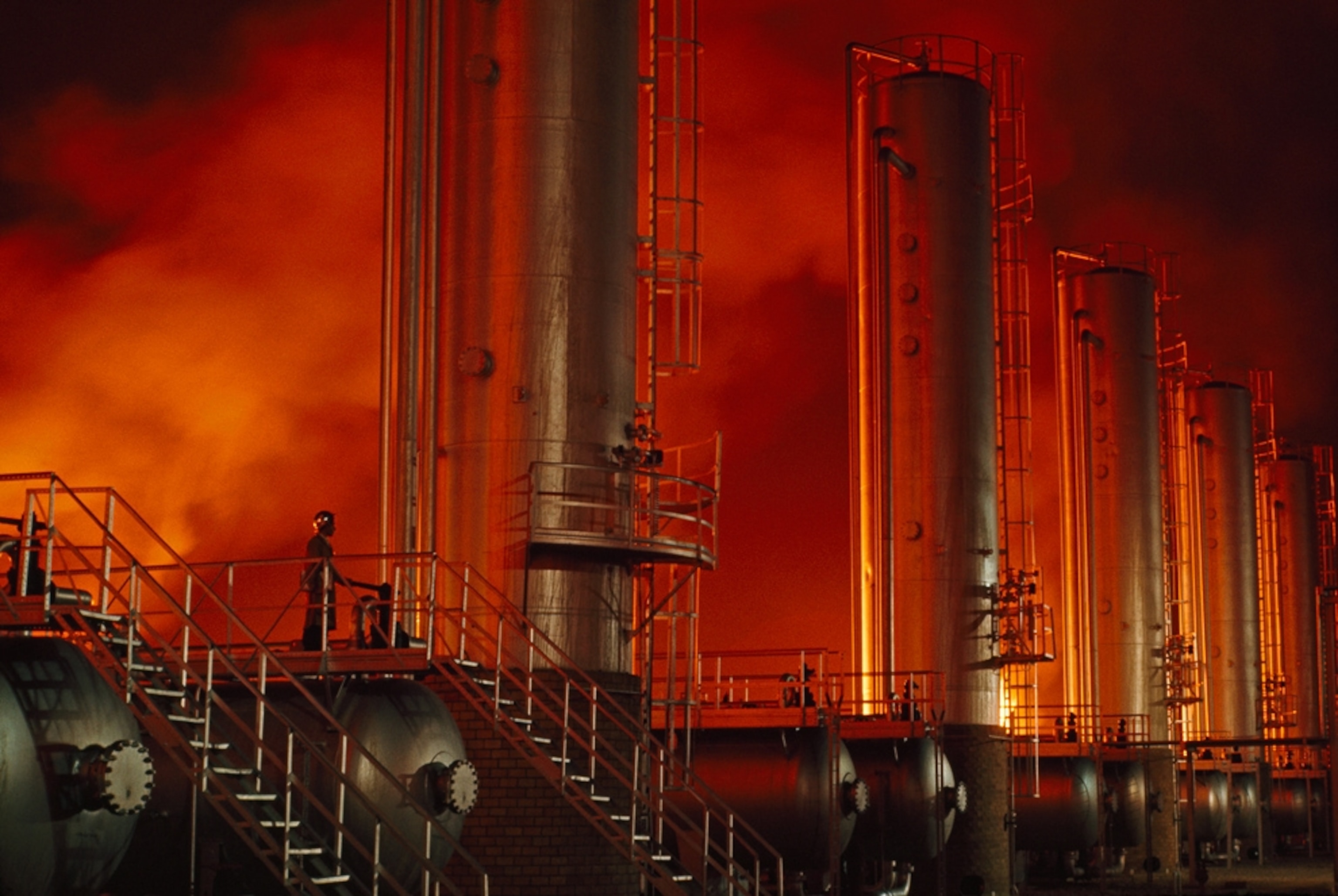 Oil-field towers reflect flaring natural gas in Iran