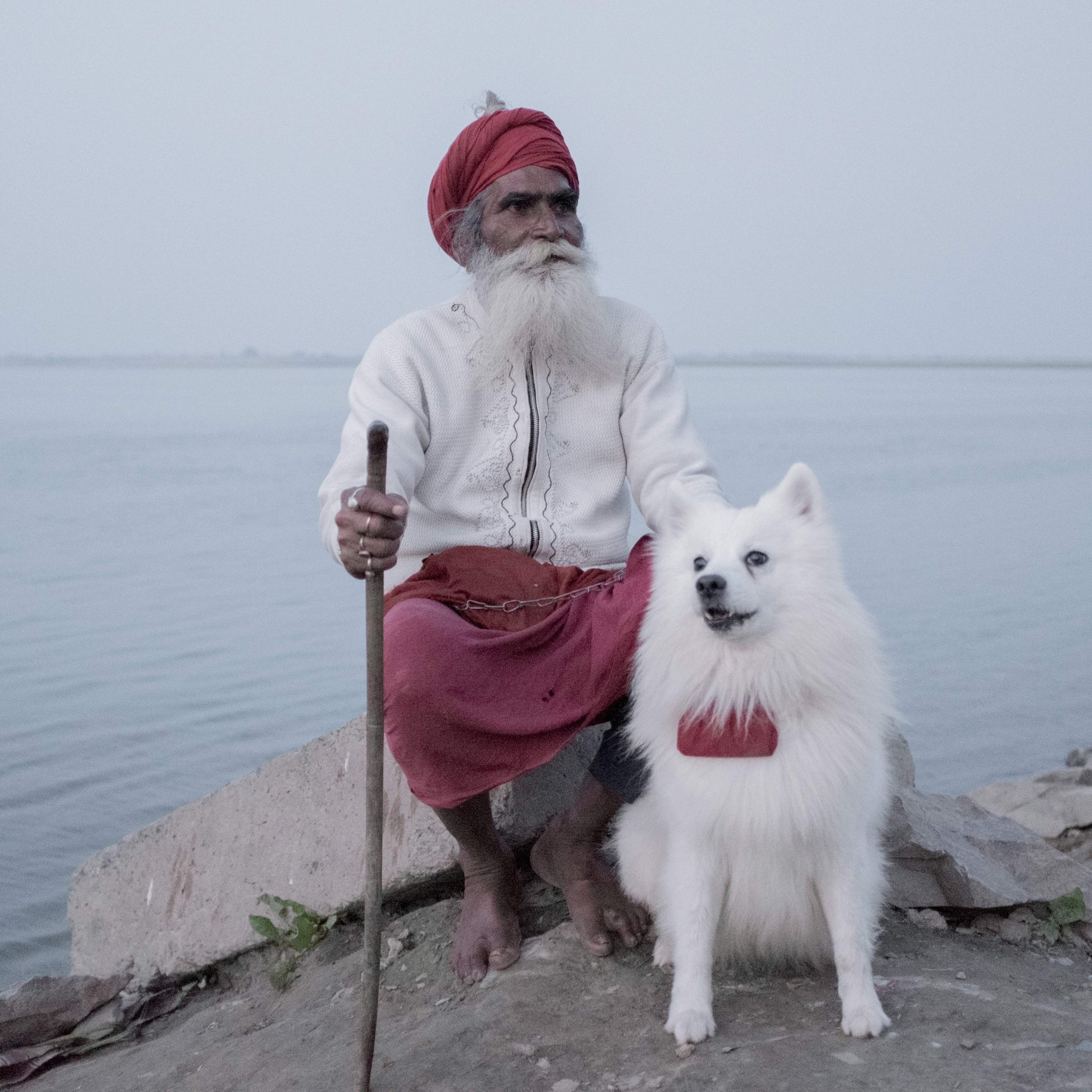 A sadhu sits with his dog in Bihar, India