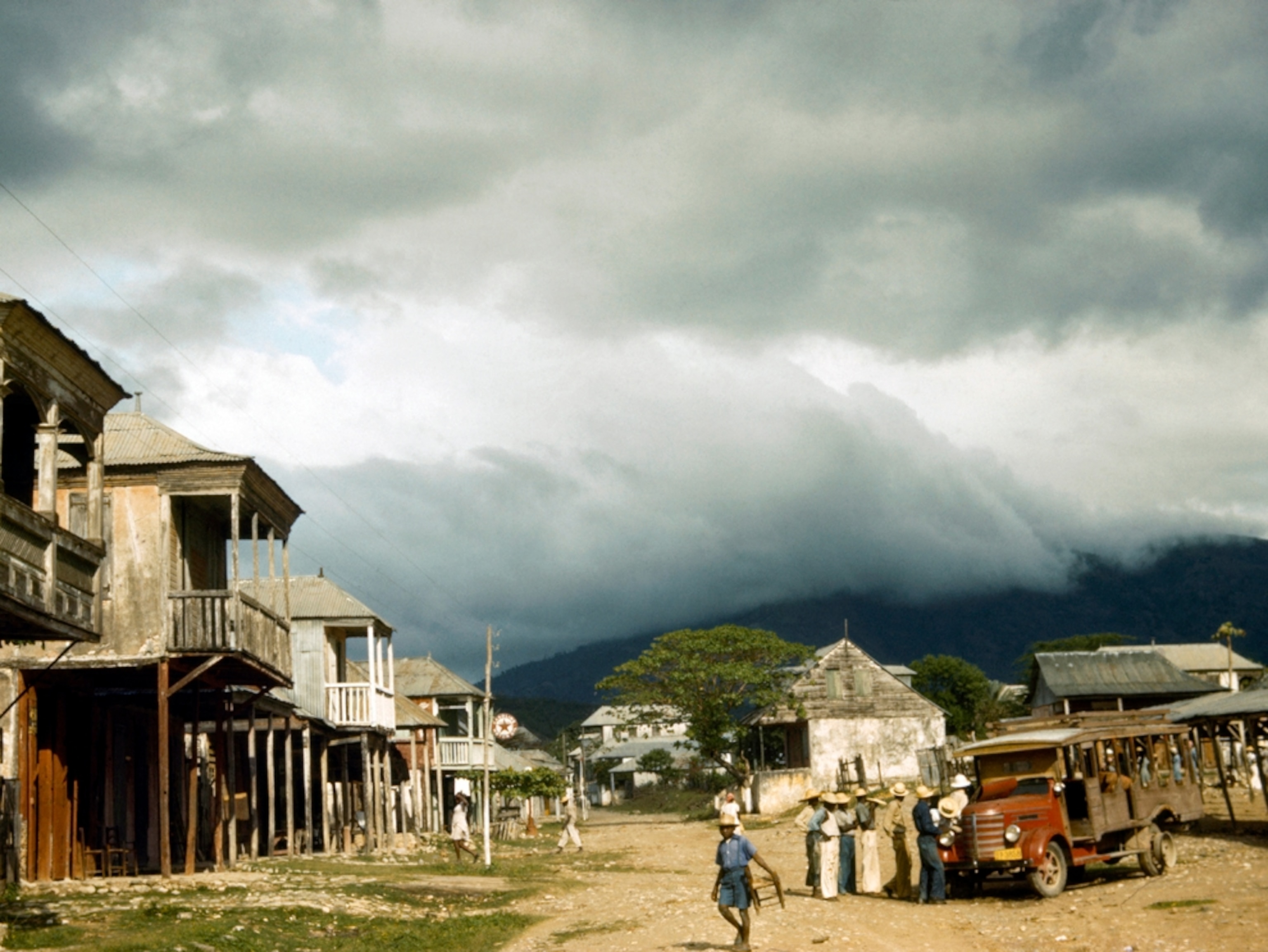 People outside houses before a storm