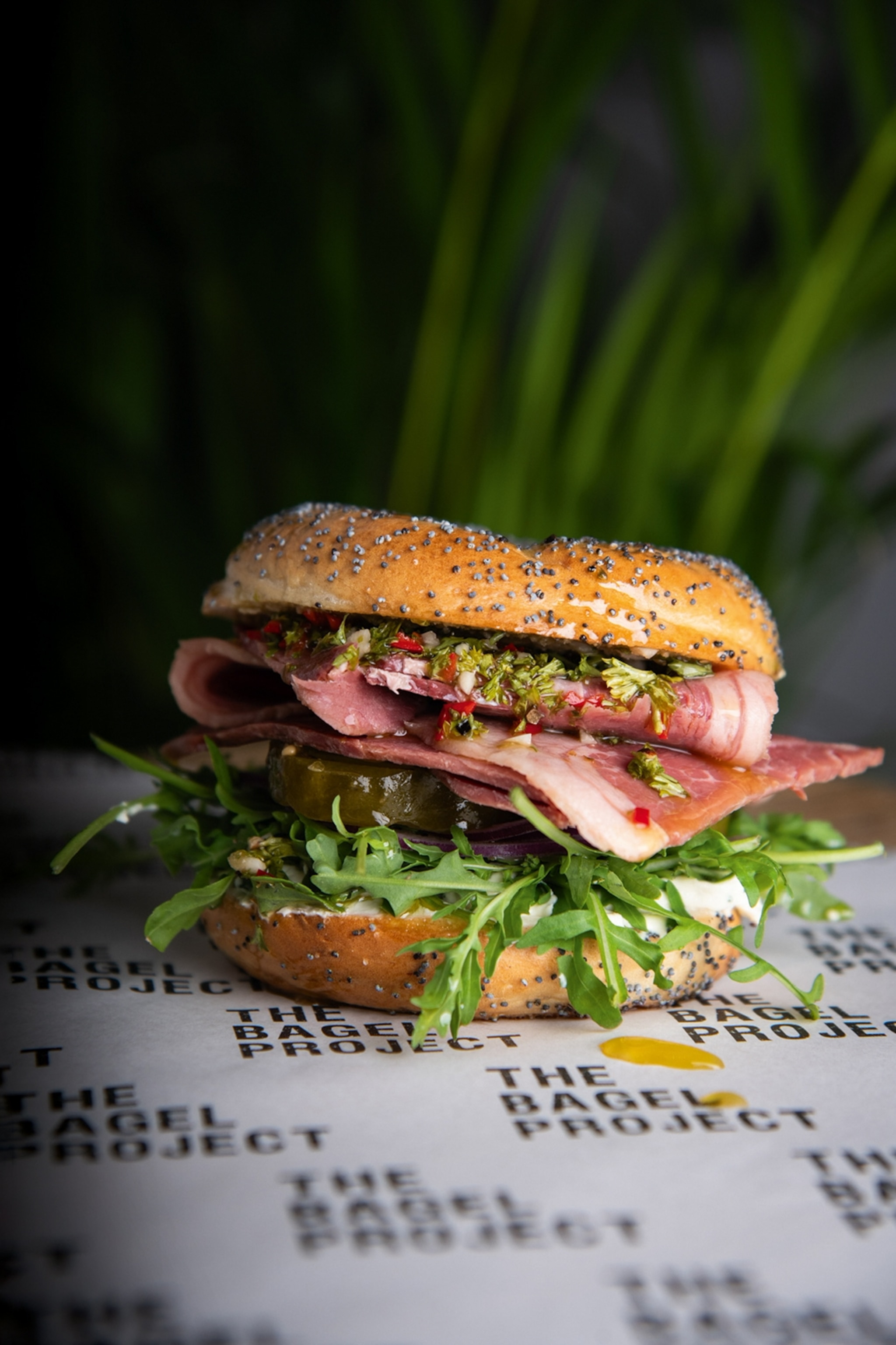 Bagel filled with pulled pork, apple and carrot slaw, and homemade barbecue sauce.