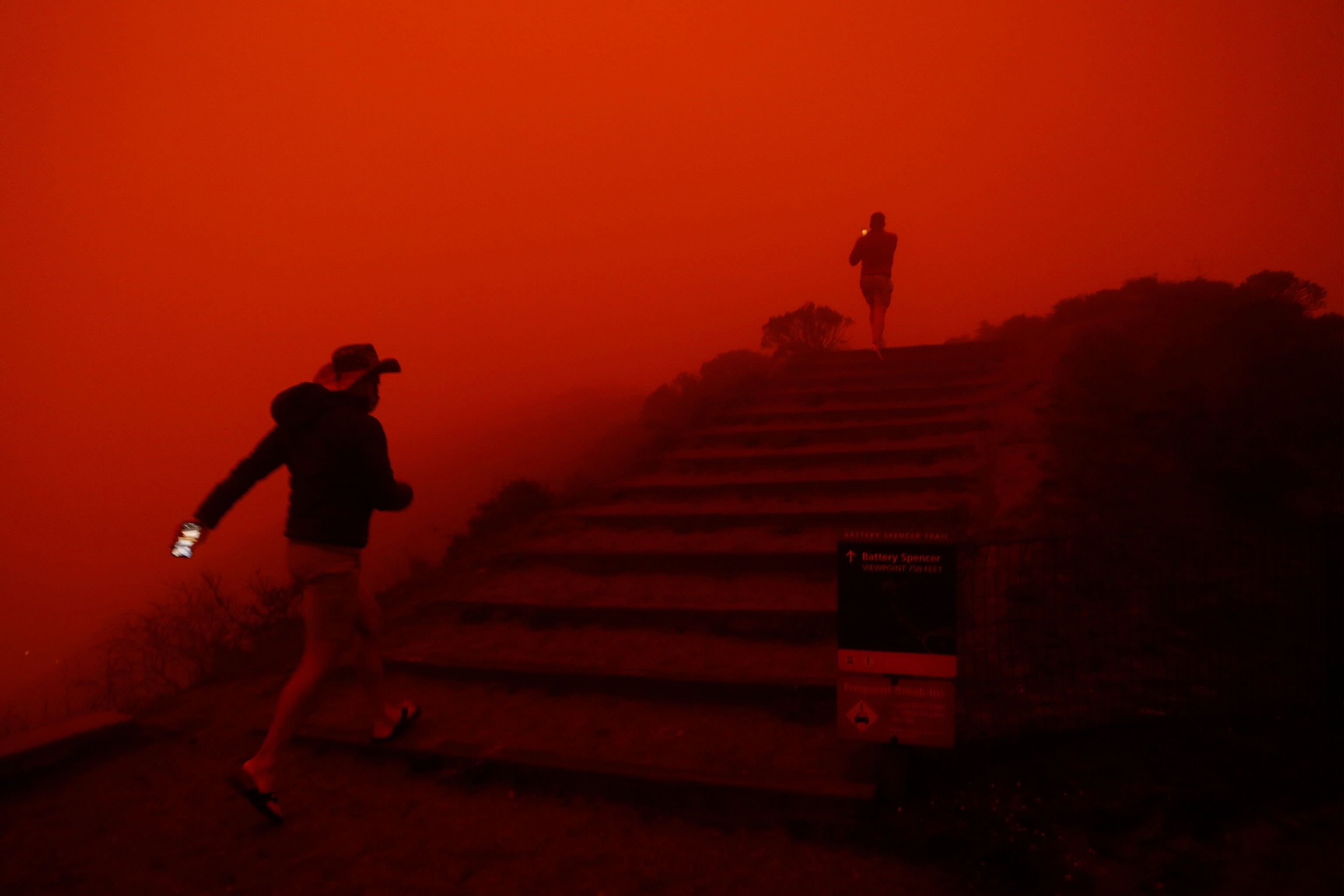 two people disappear into the red hazy smoke