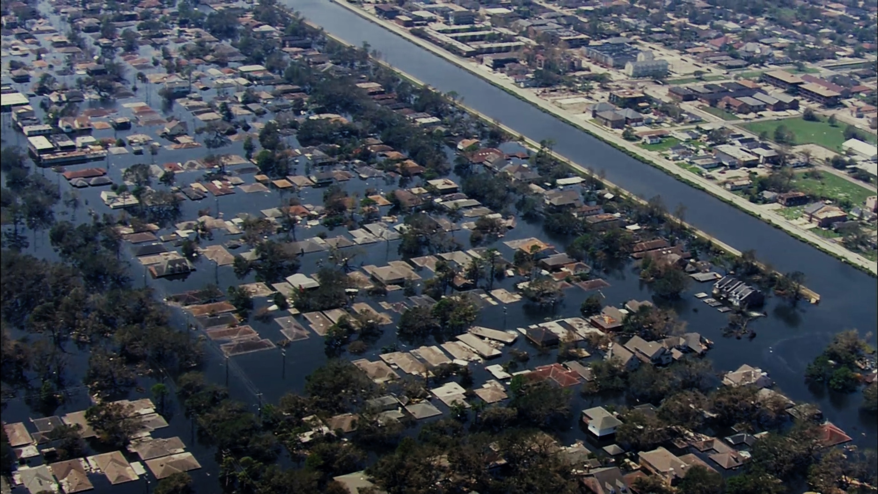 An aerial view of a broken levee after Hurricane Katrina.