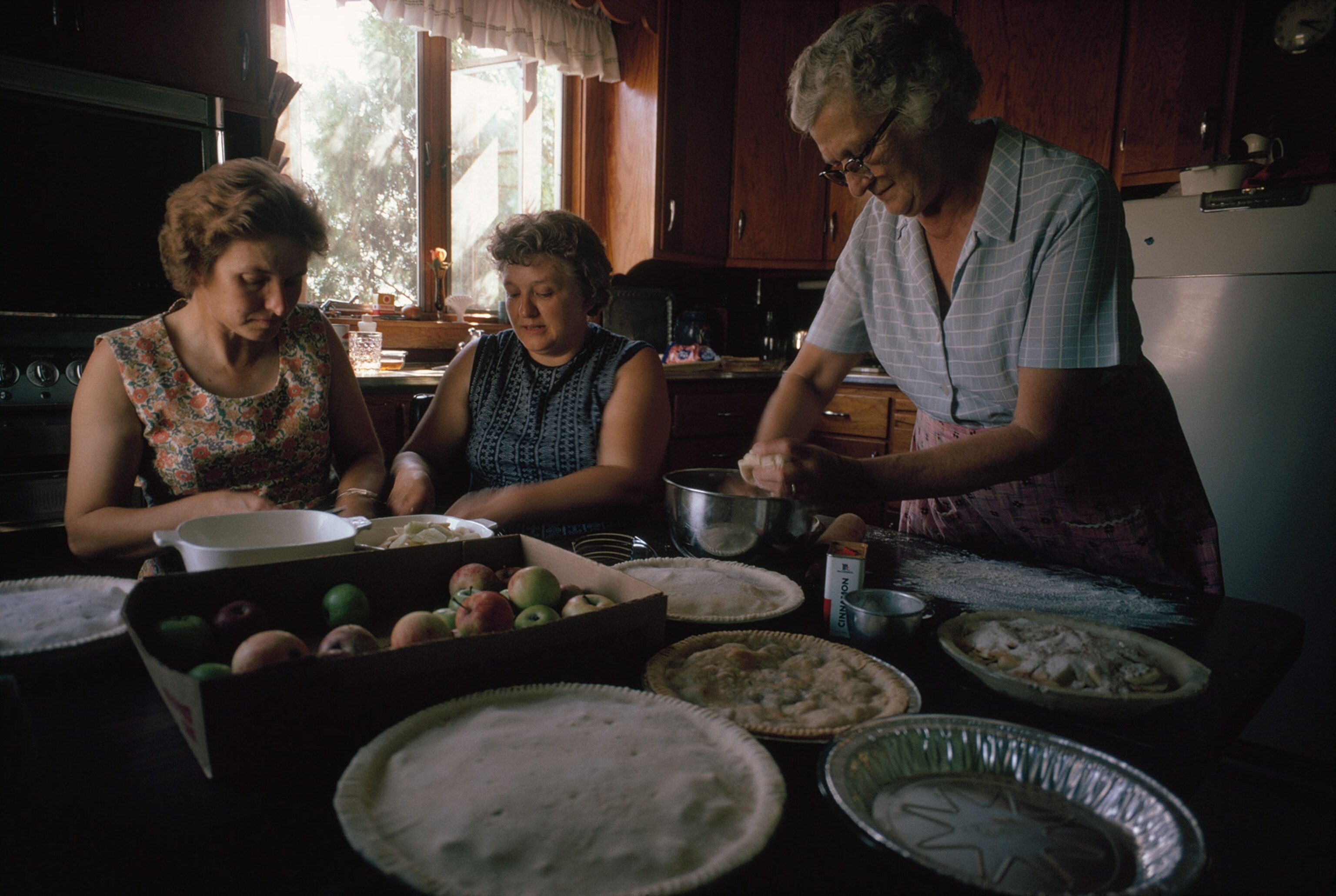 a farming family making apple pies for the freezer