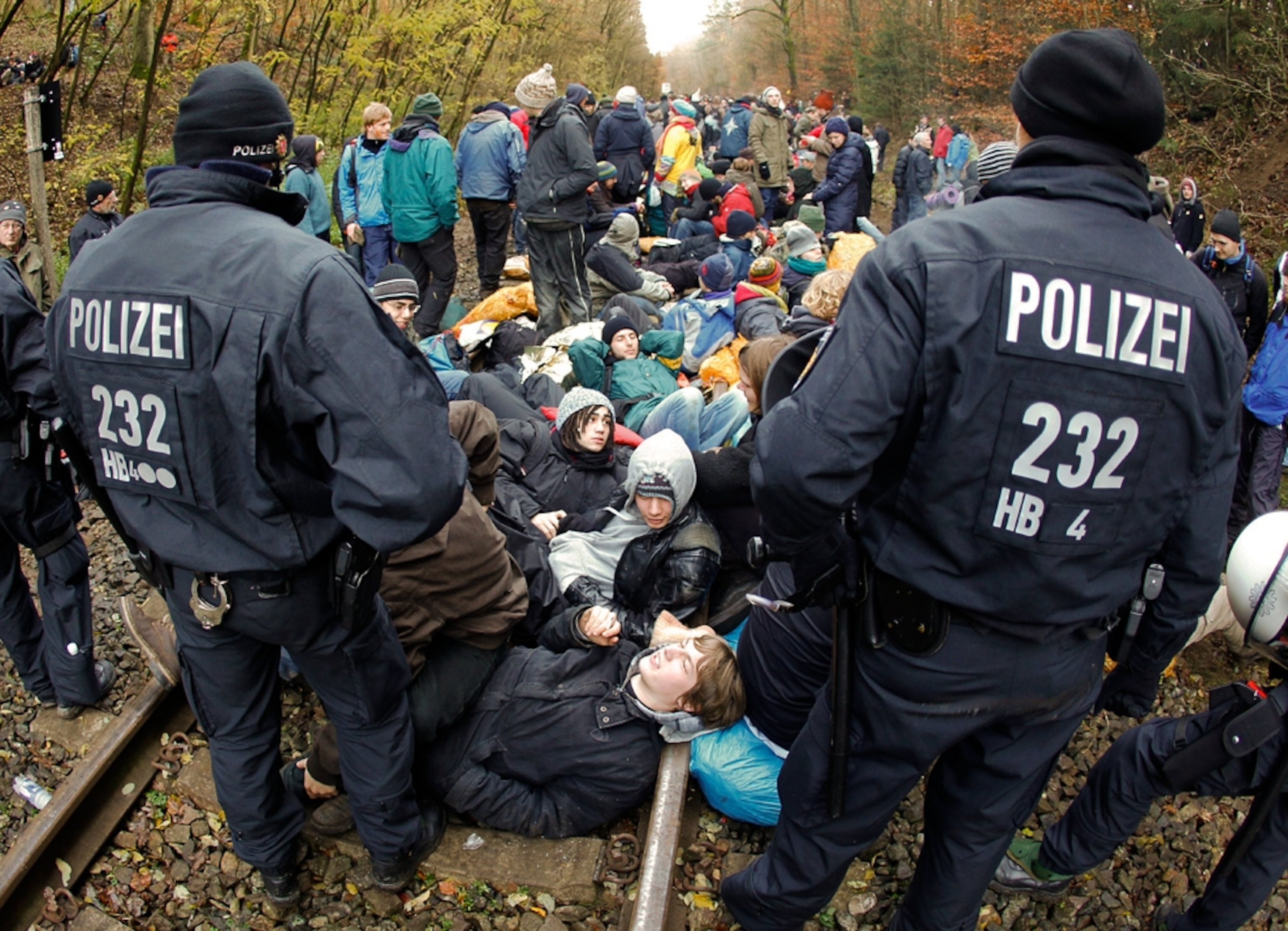 Police stand by as dozens of antinuclear protesters sit on a set of railroad tracks (picture)