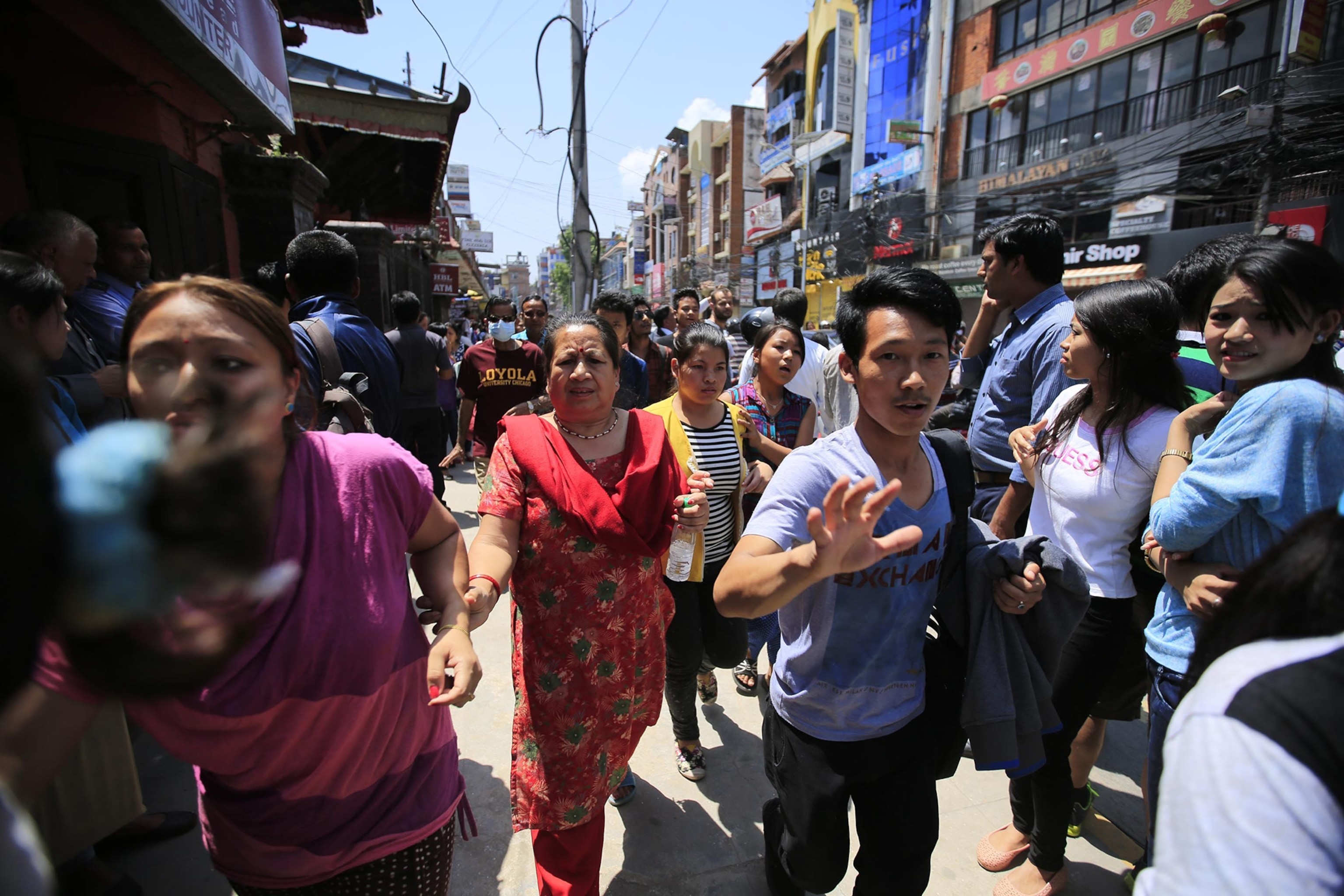 People escape after a magnitude 7.3 earthquake has hit Nepal