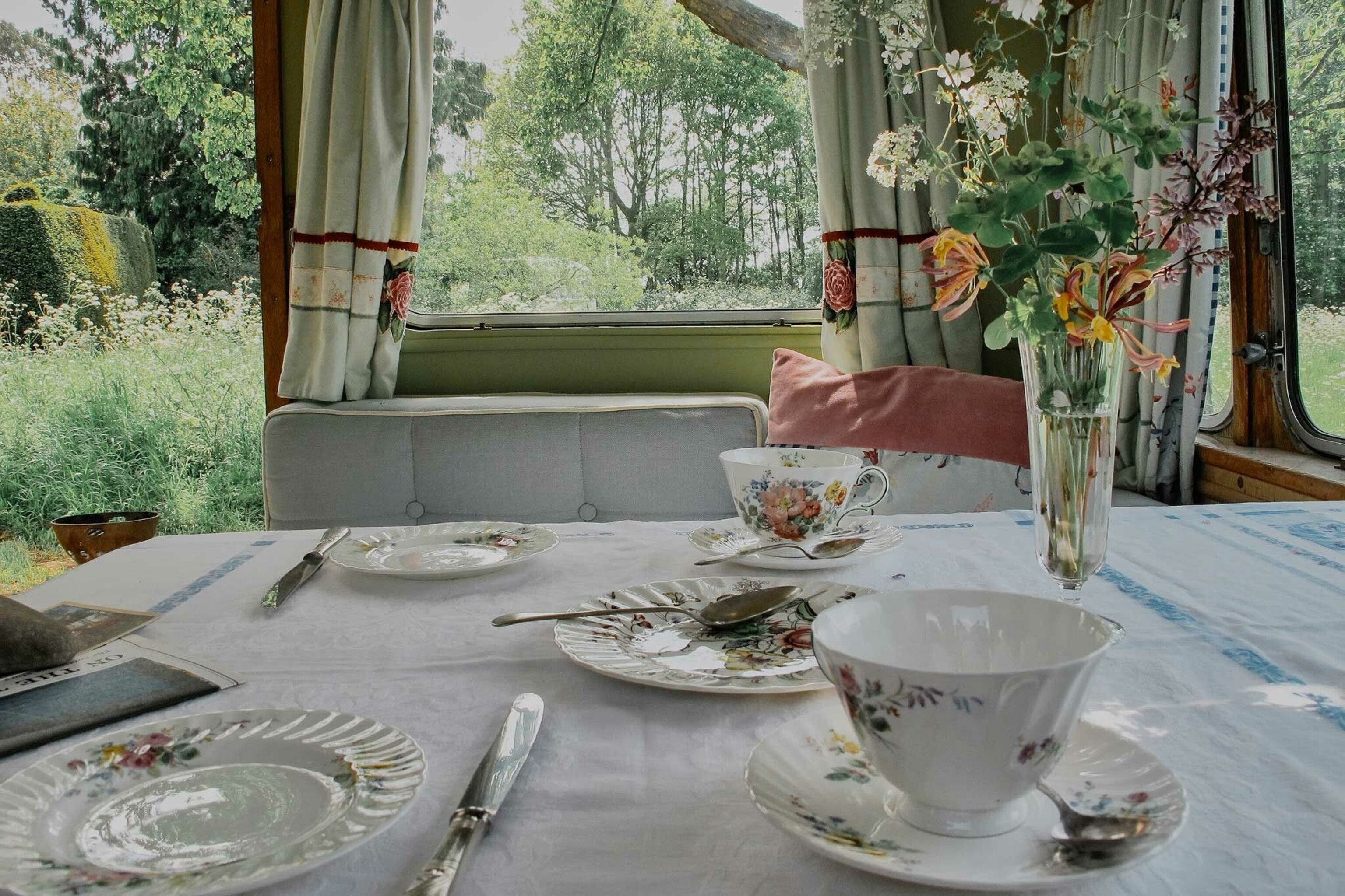 Mad Dogs is a cluster of four eclectic vintage vans tucked into a Wye Valley meadow.