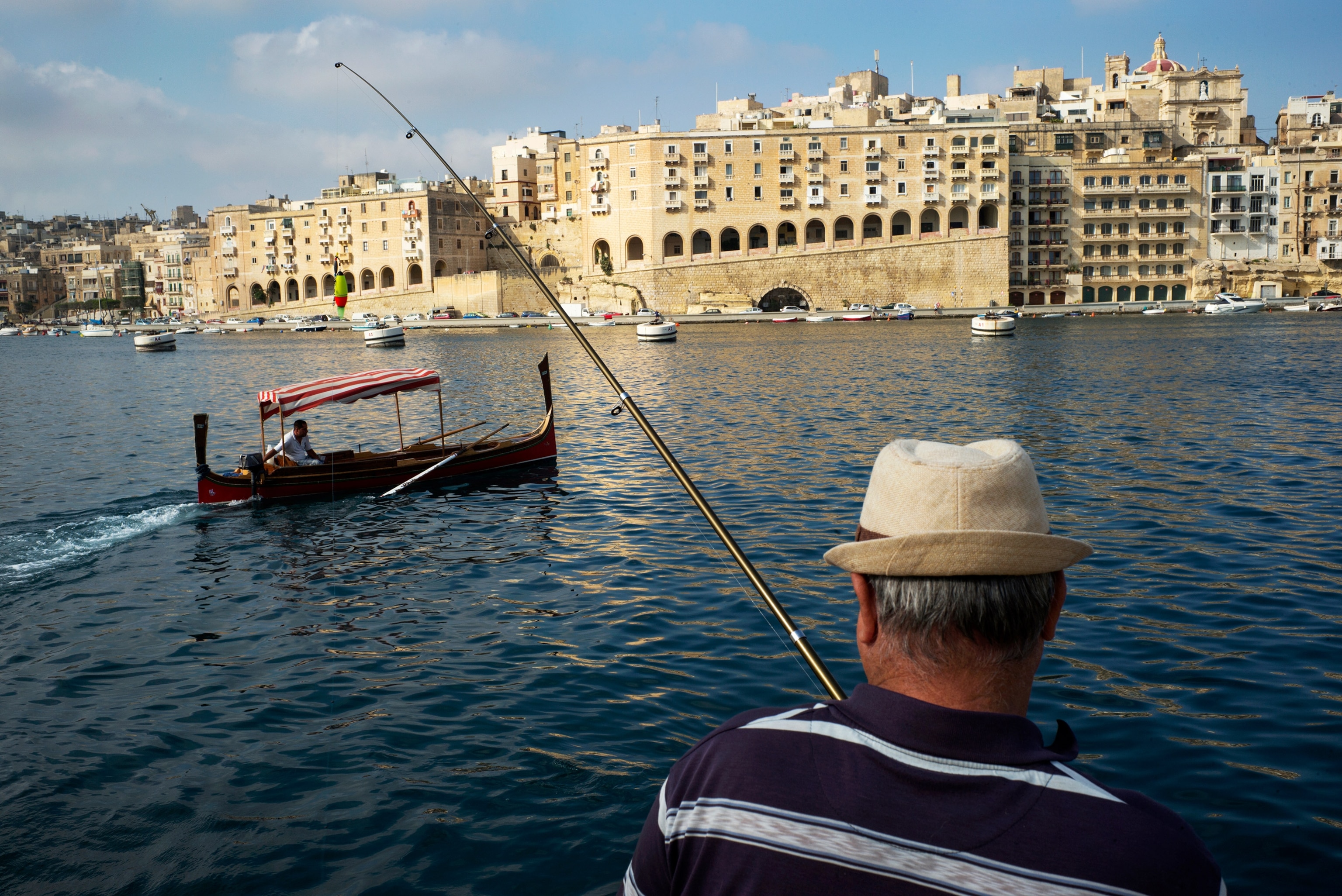 a fisherman at the Grand Harbor, Malta