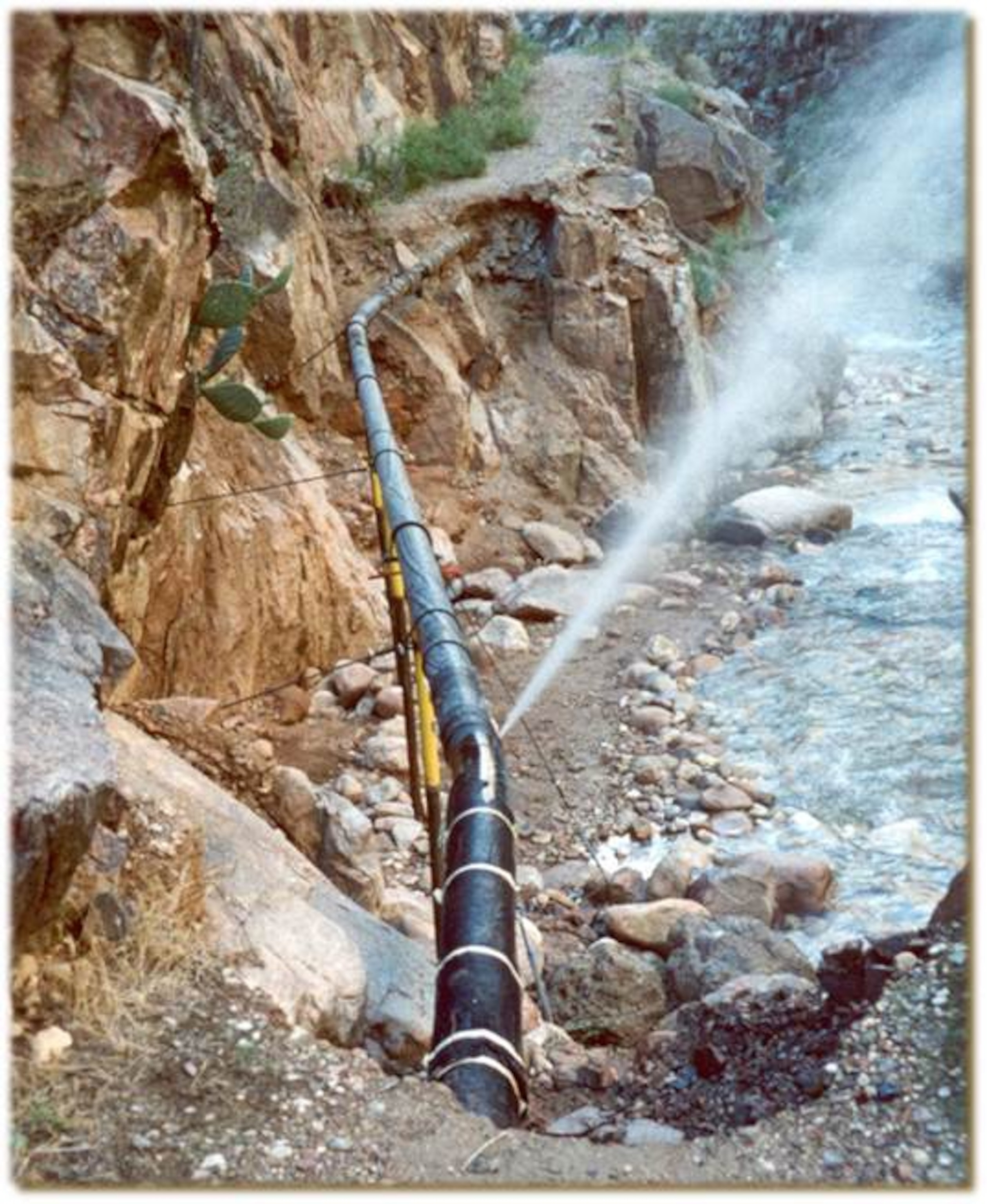 water spraying from a busted pipe in the grand canyon waterline system