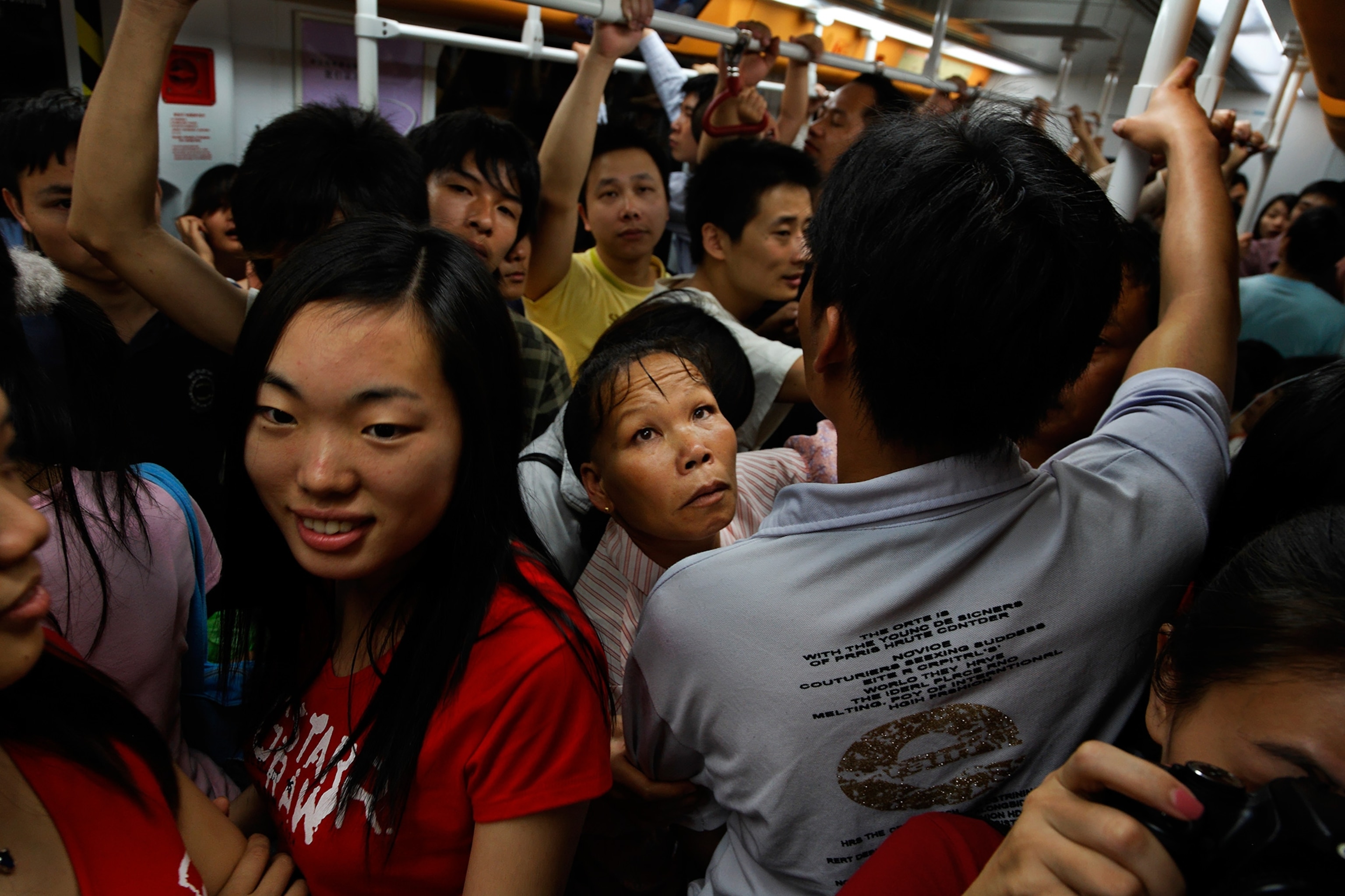 a woman on a crowded train on the Guangzhou Metro