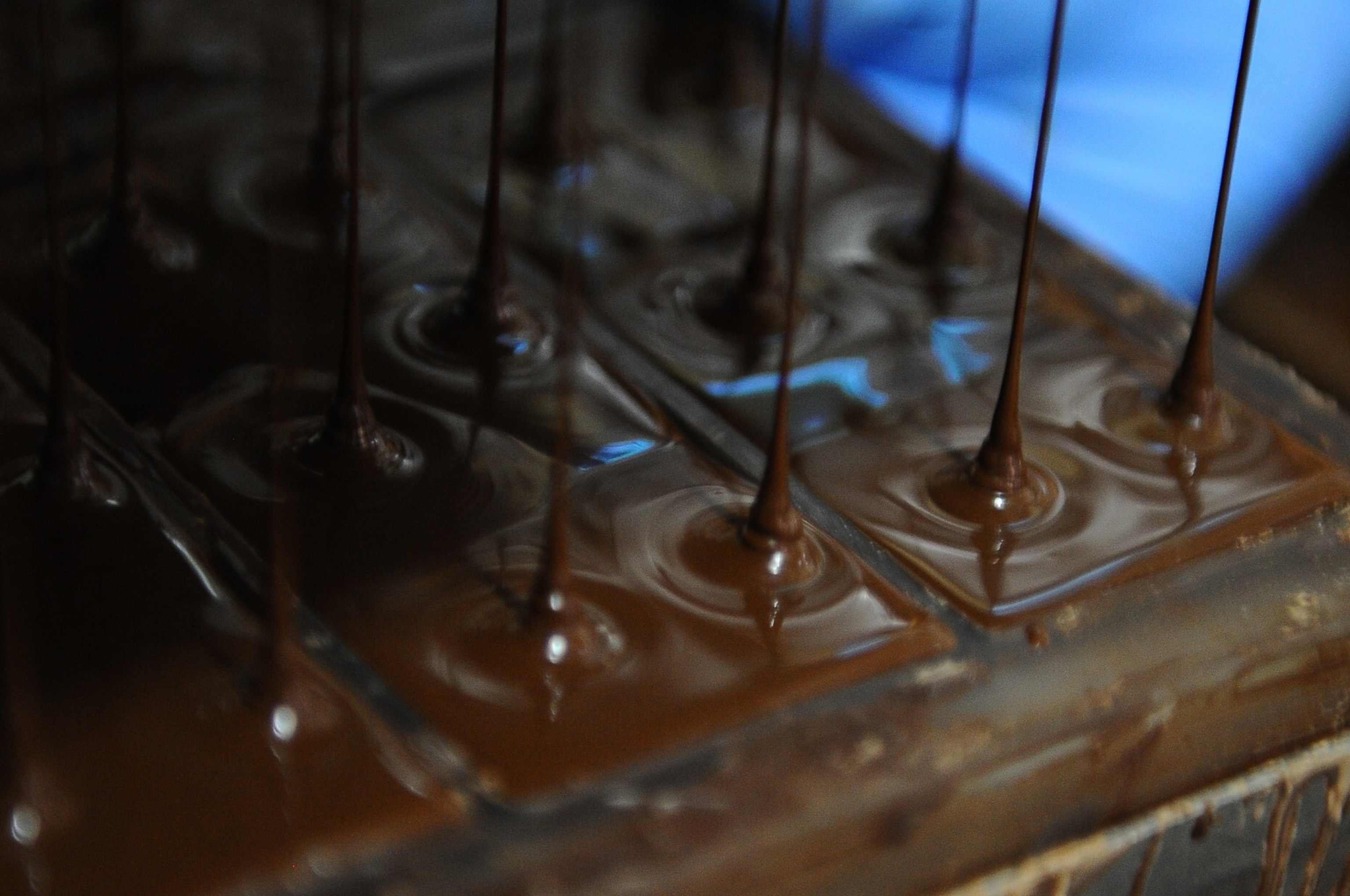 chocolate melts in a mold at the Pacari chocolate factory in southern Quito
