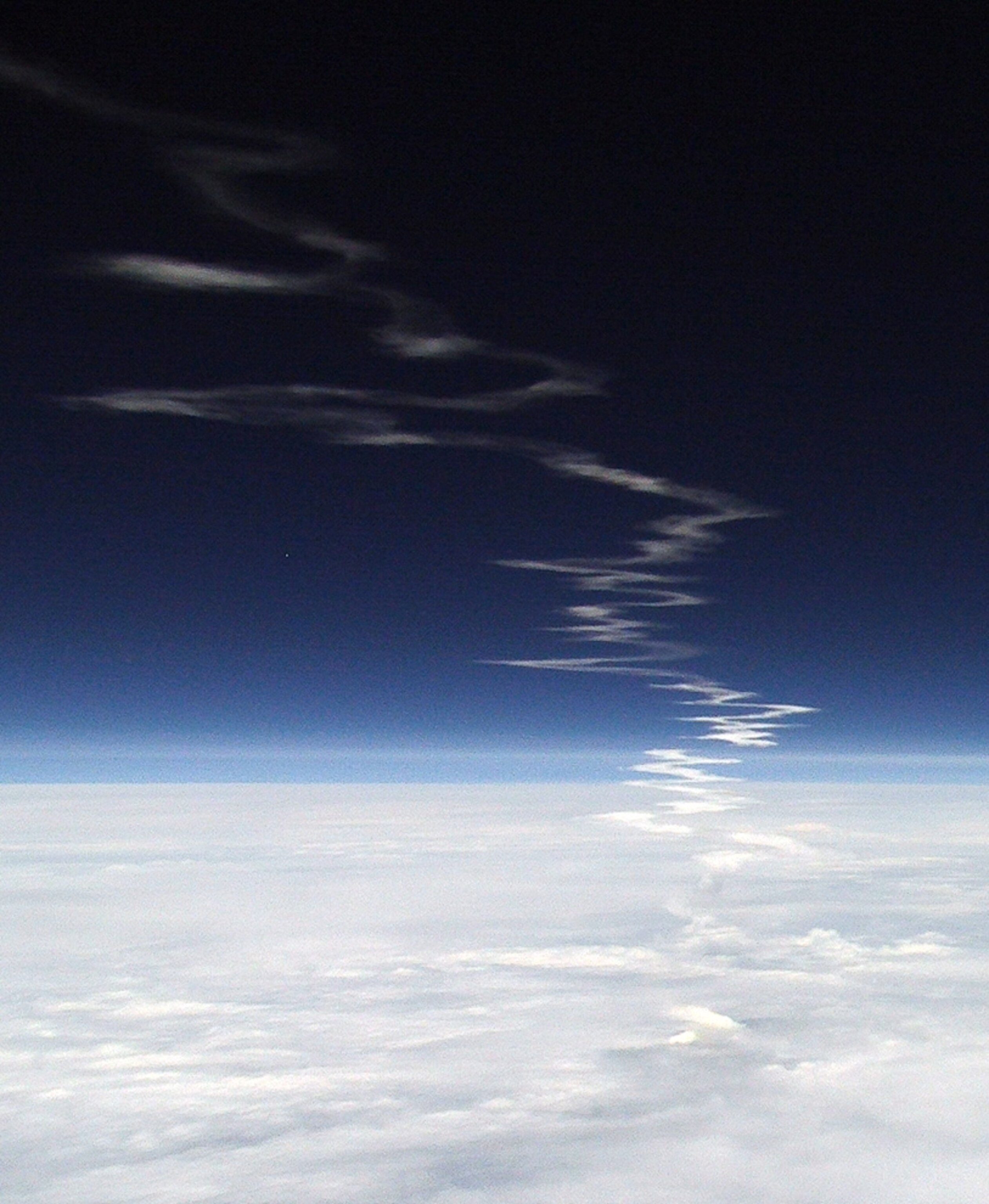 the trail of the space shuttle Atlantis as seen from a high-altitude balloon.