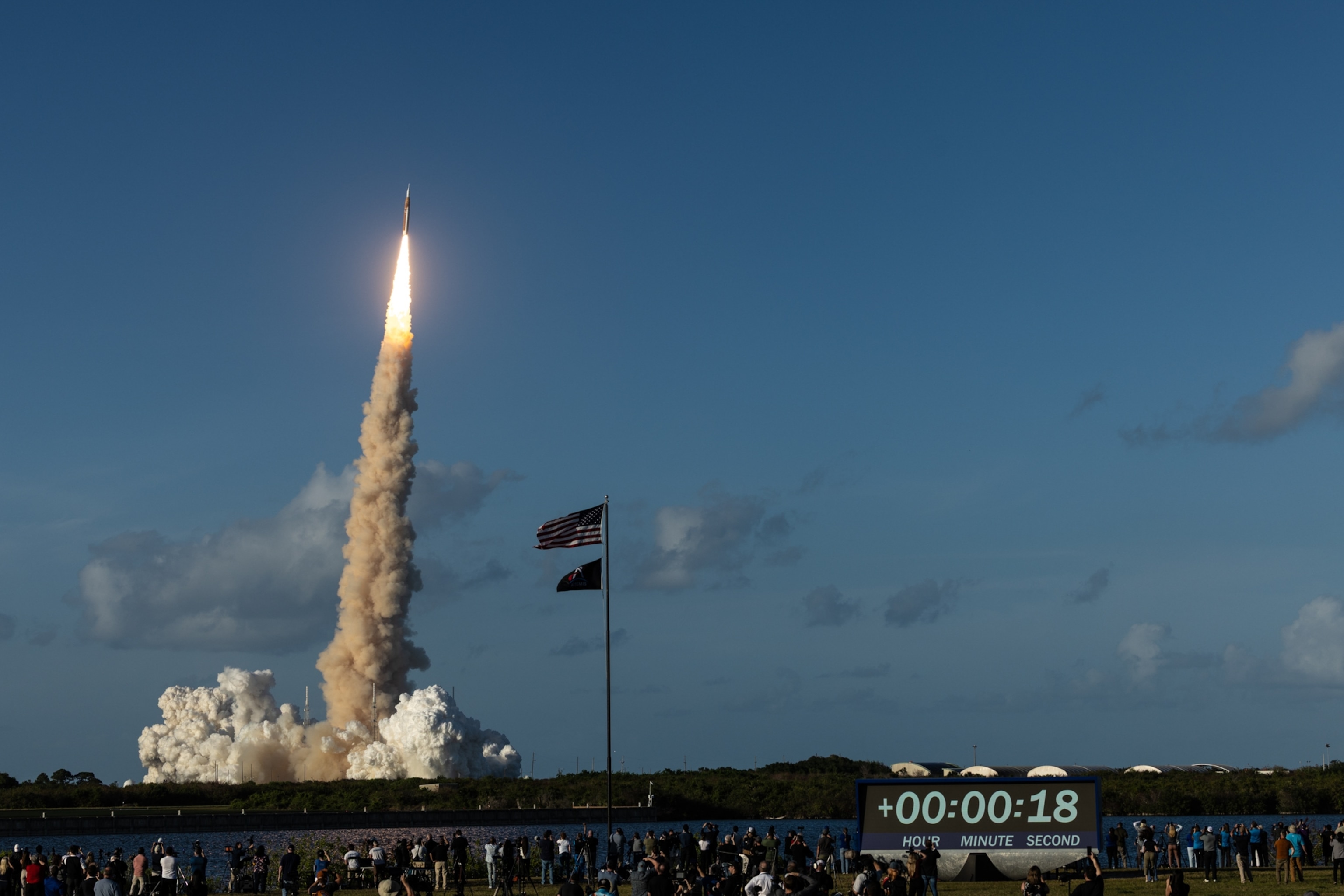 Rocket launch with a bright trail against a clear blue sky, liftoff at 18 seconds.