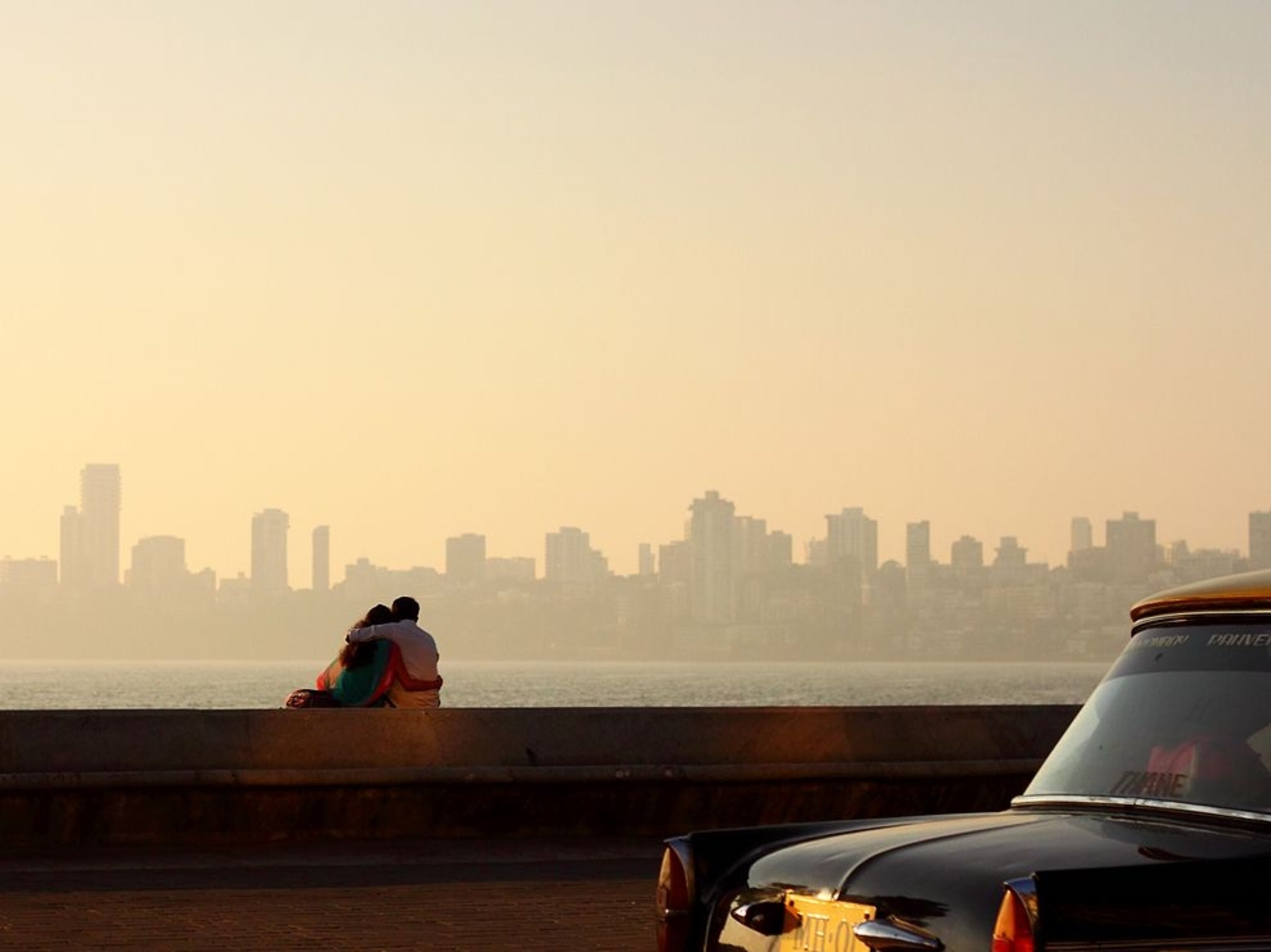 a couple siting at Marine Drive in Mumbai, India