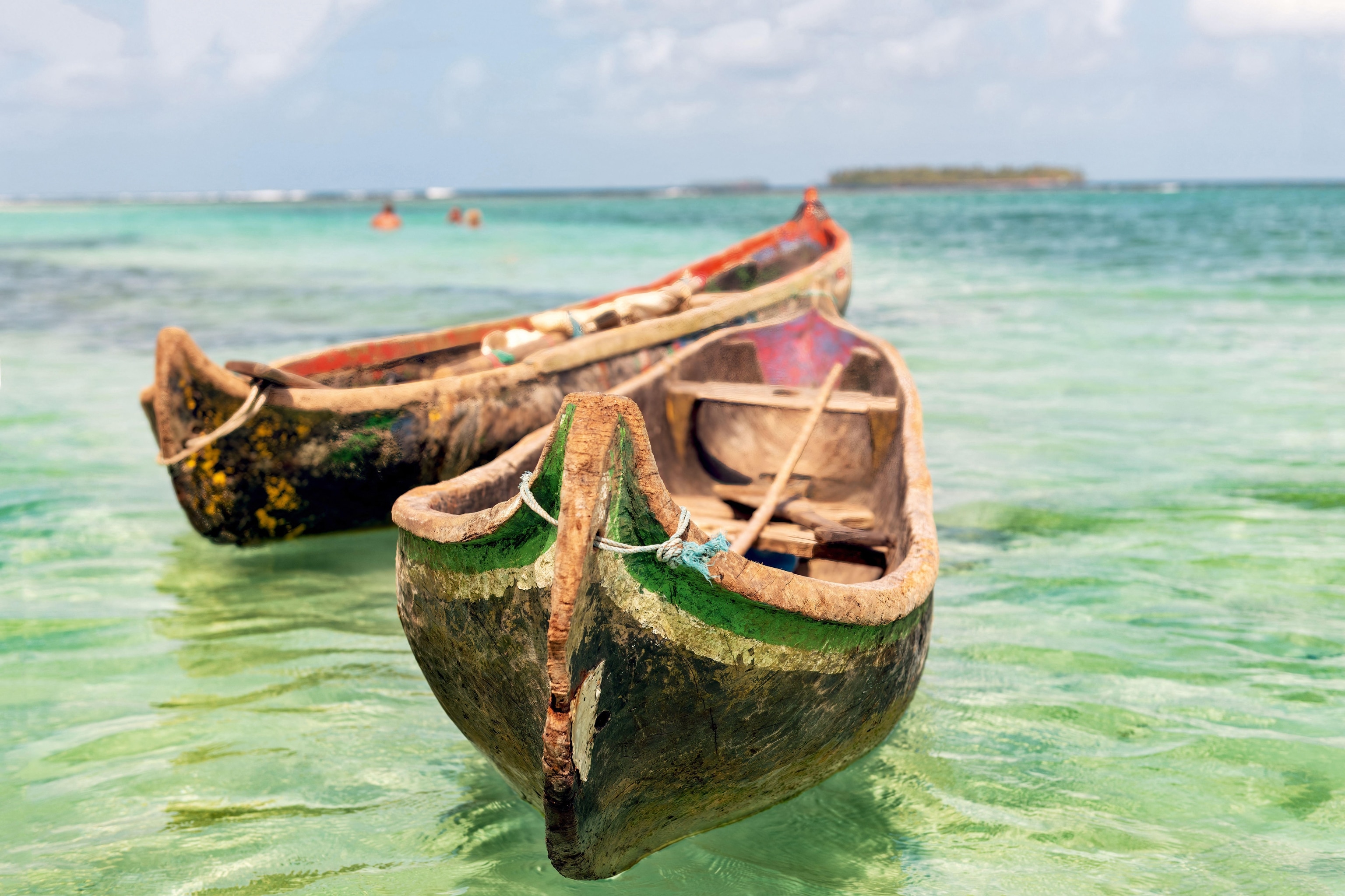 Two wooden canoes on the water