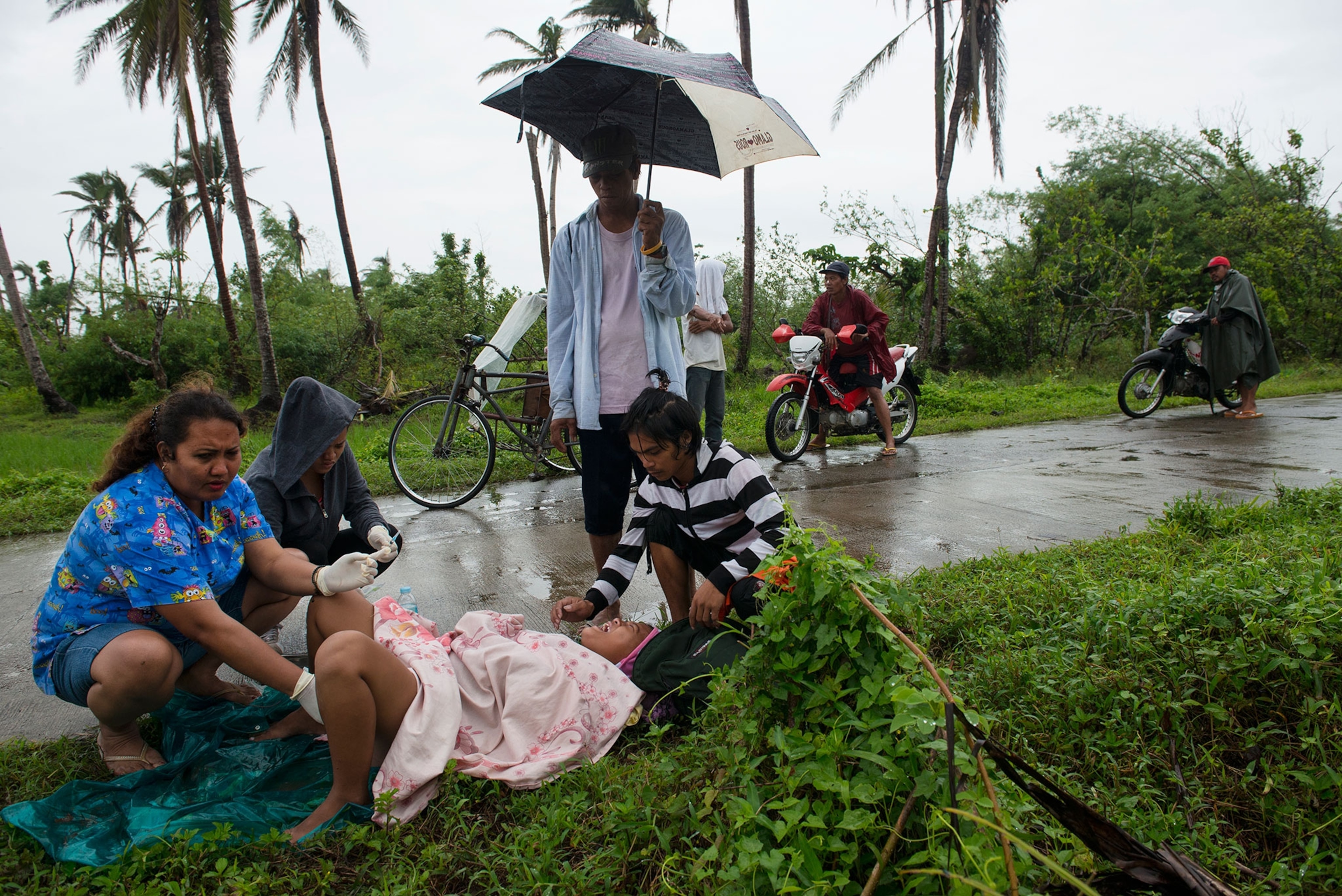 woman giving birth on side of the road