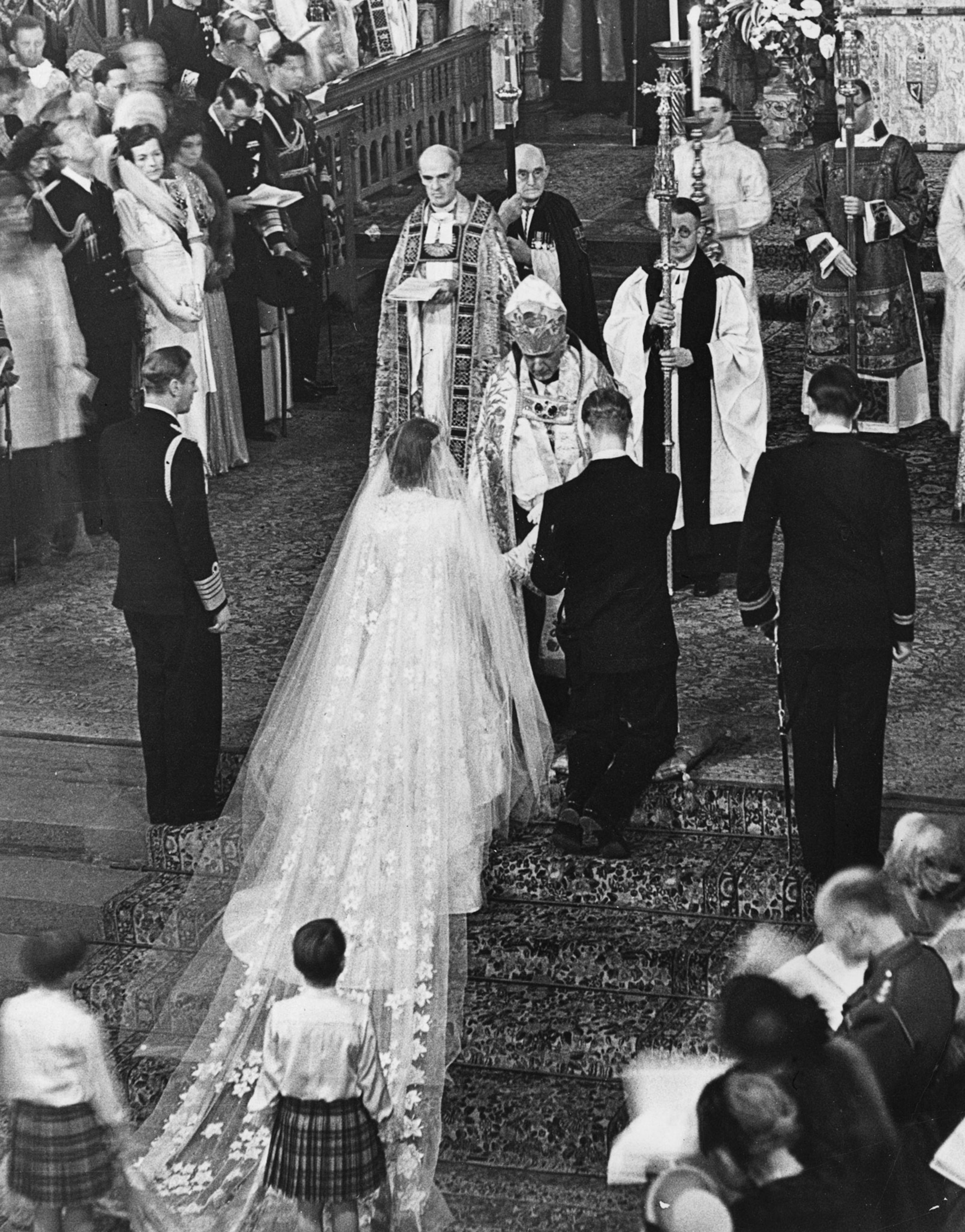 the Queen and The Duke of Edinburgh receiving a blessing from the Archbishop