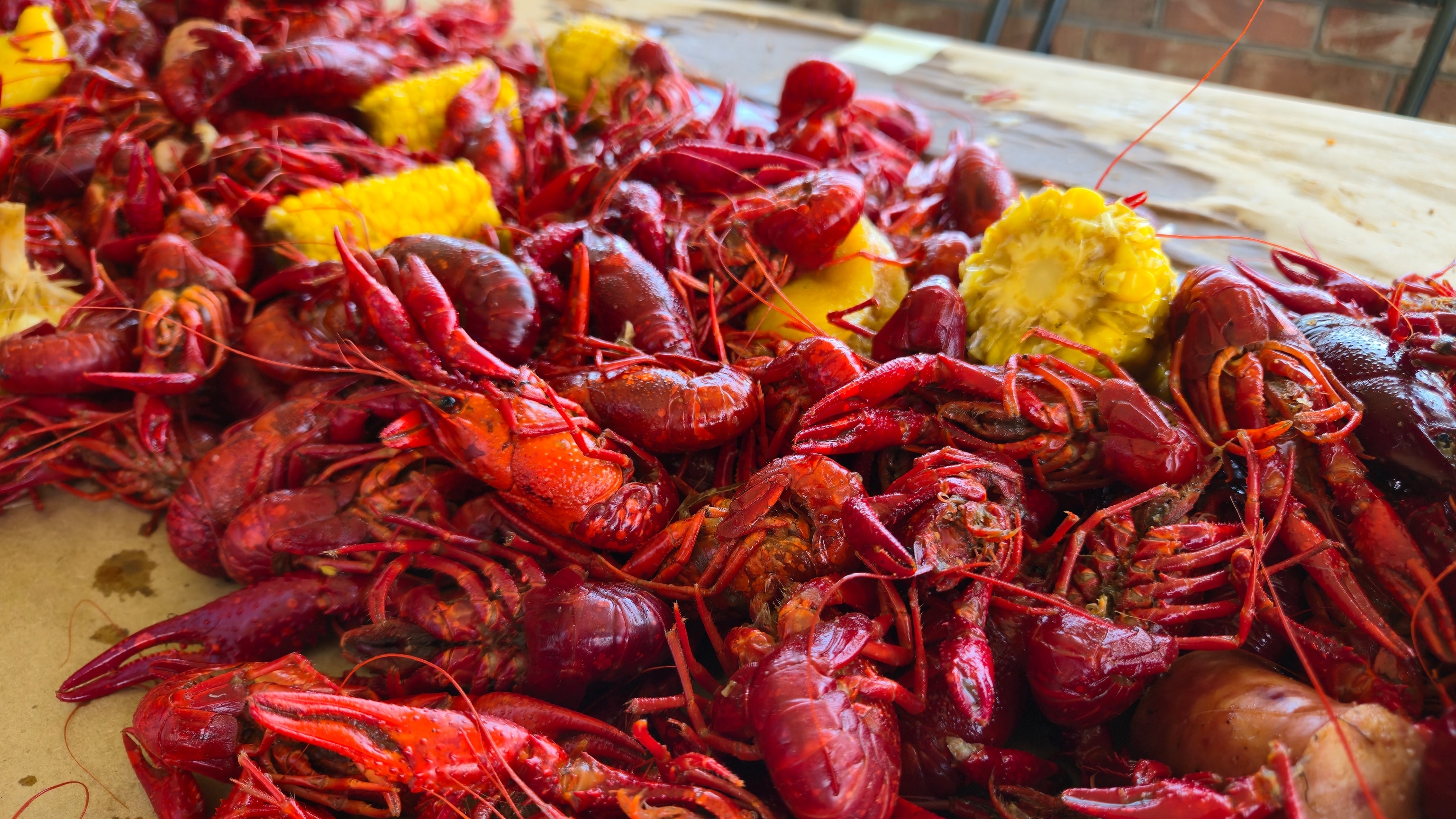 At crawfish boils, locals come together to cook the day's catch in large pots with spicy seasoning, corn, potatoes, sausage and garlic