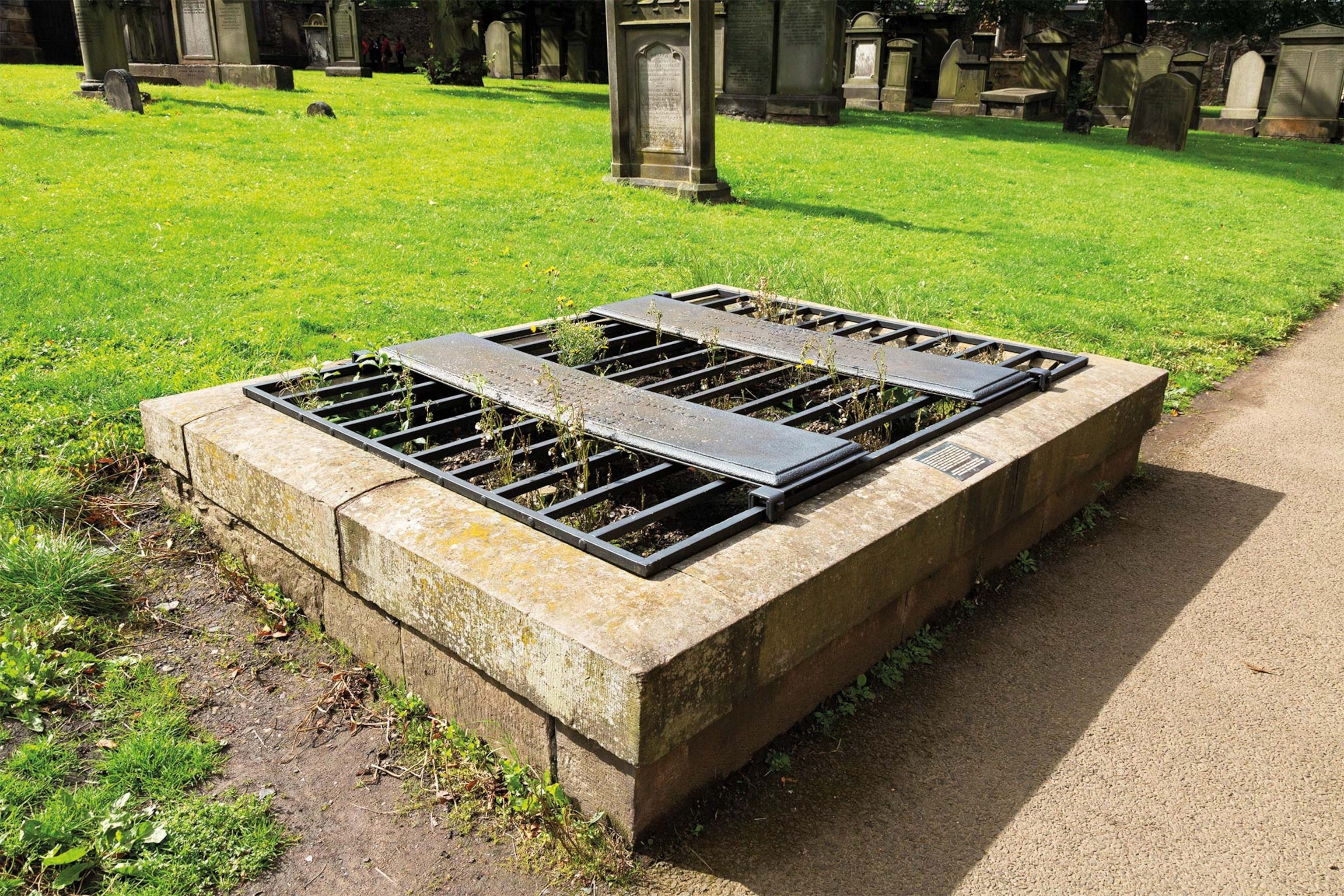 A mortsafe over a grave in Greyfriars Kirkland Cemetery in Edinburgh, Scotland