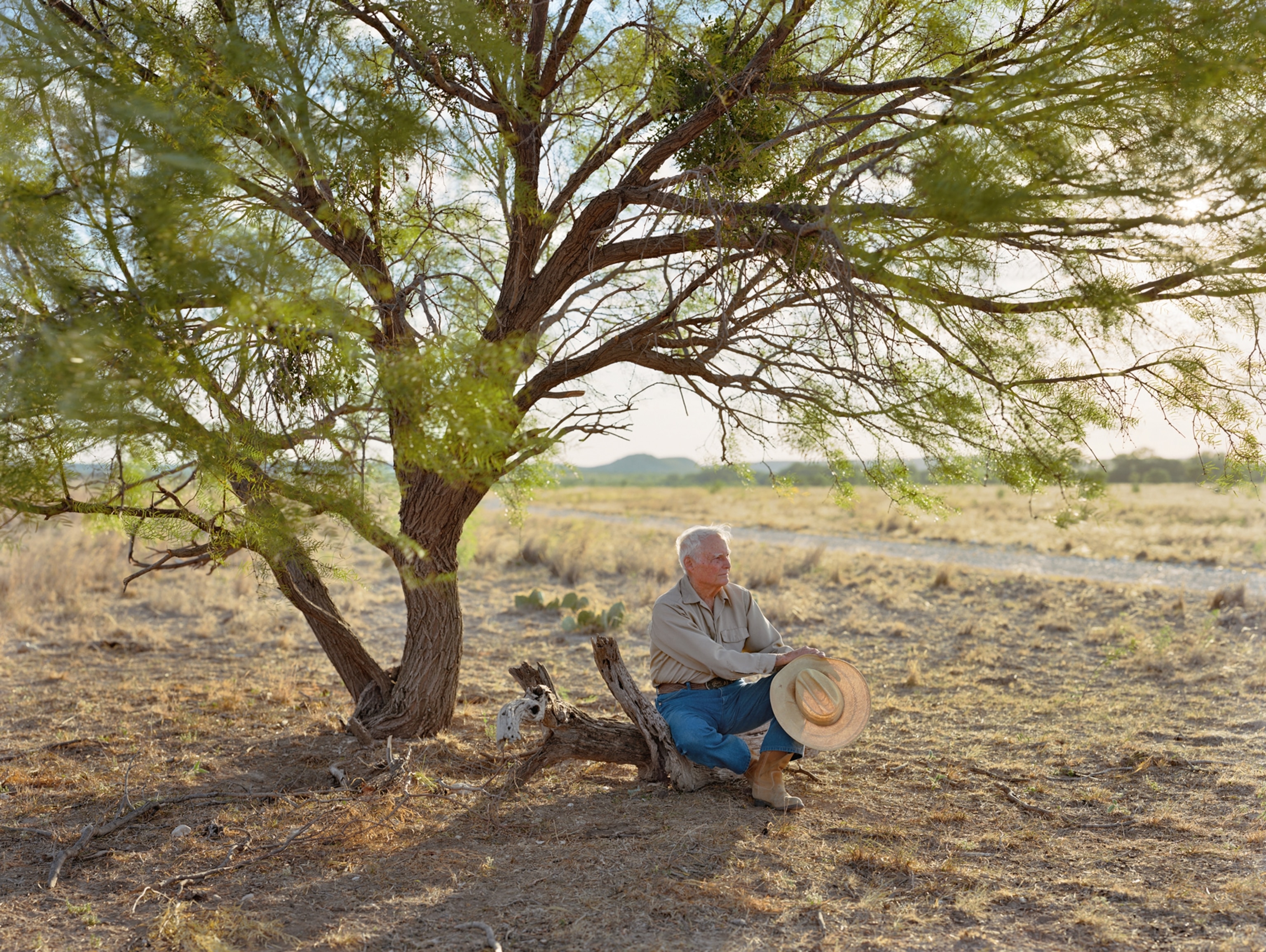 Bill Tullos sitting under a tree in San Angelo, Texas