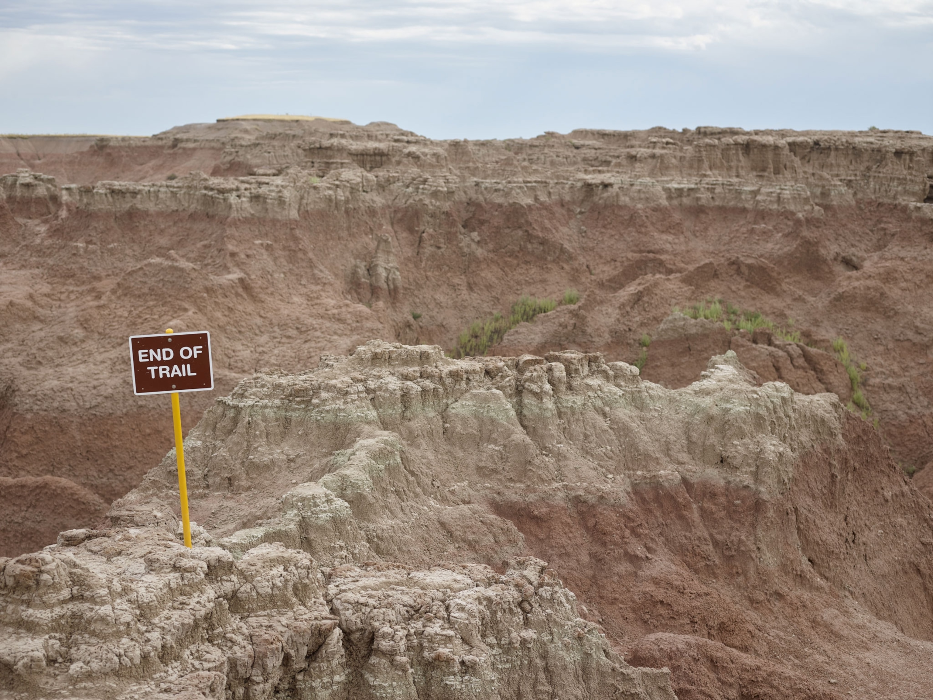 sign reading "end of trail" in a rocky landscape in the Badlands