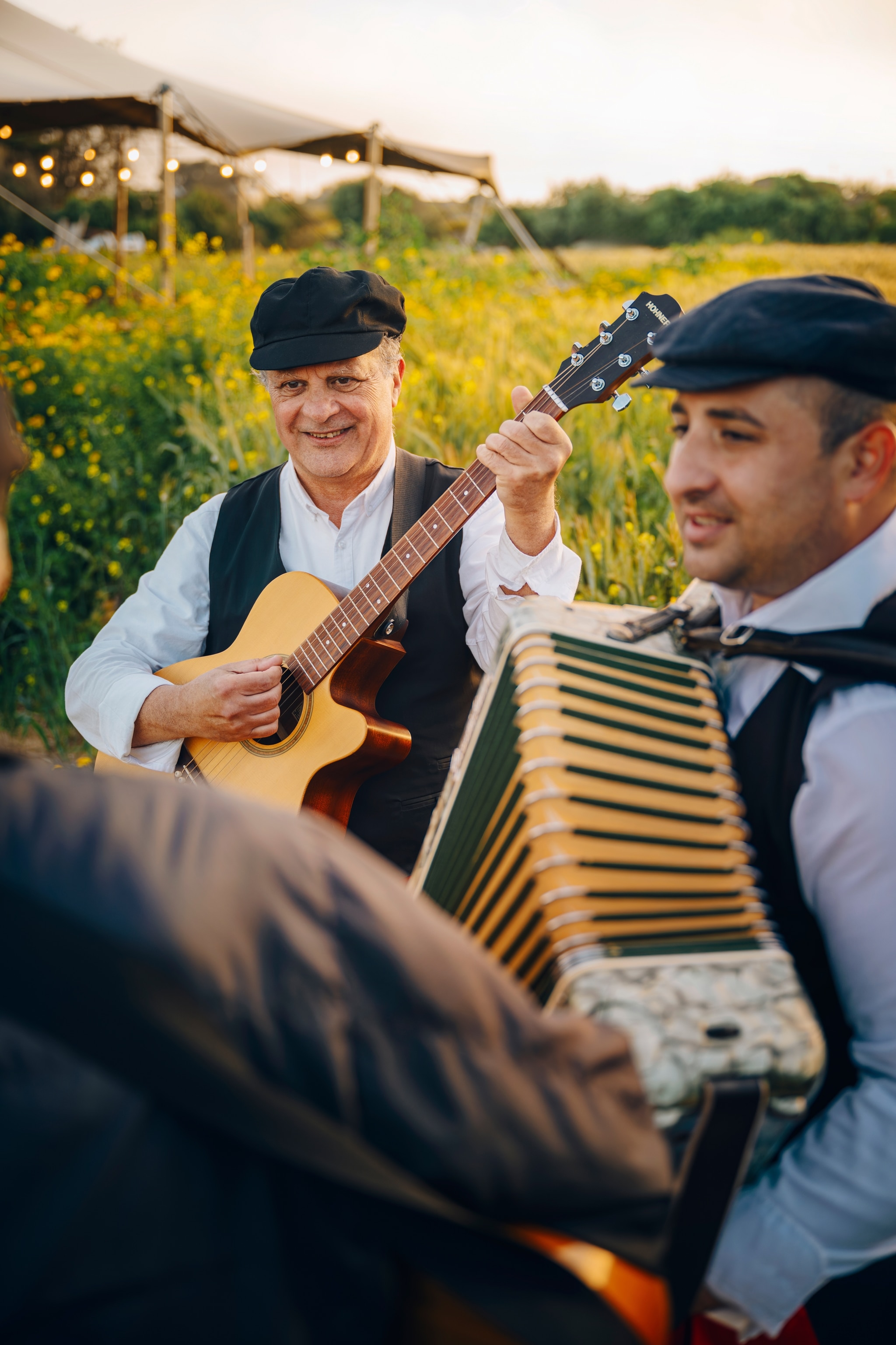 Two men playing guitar and accordion