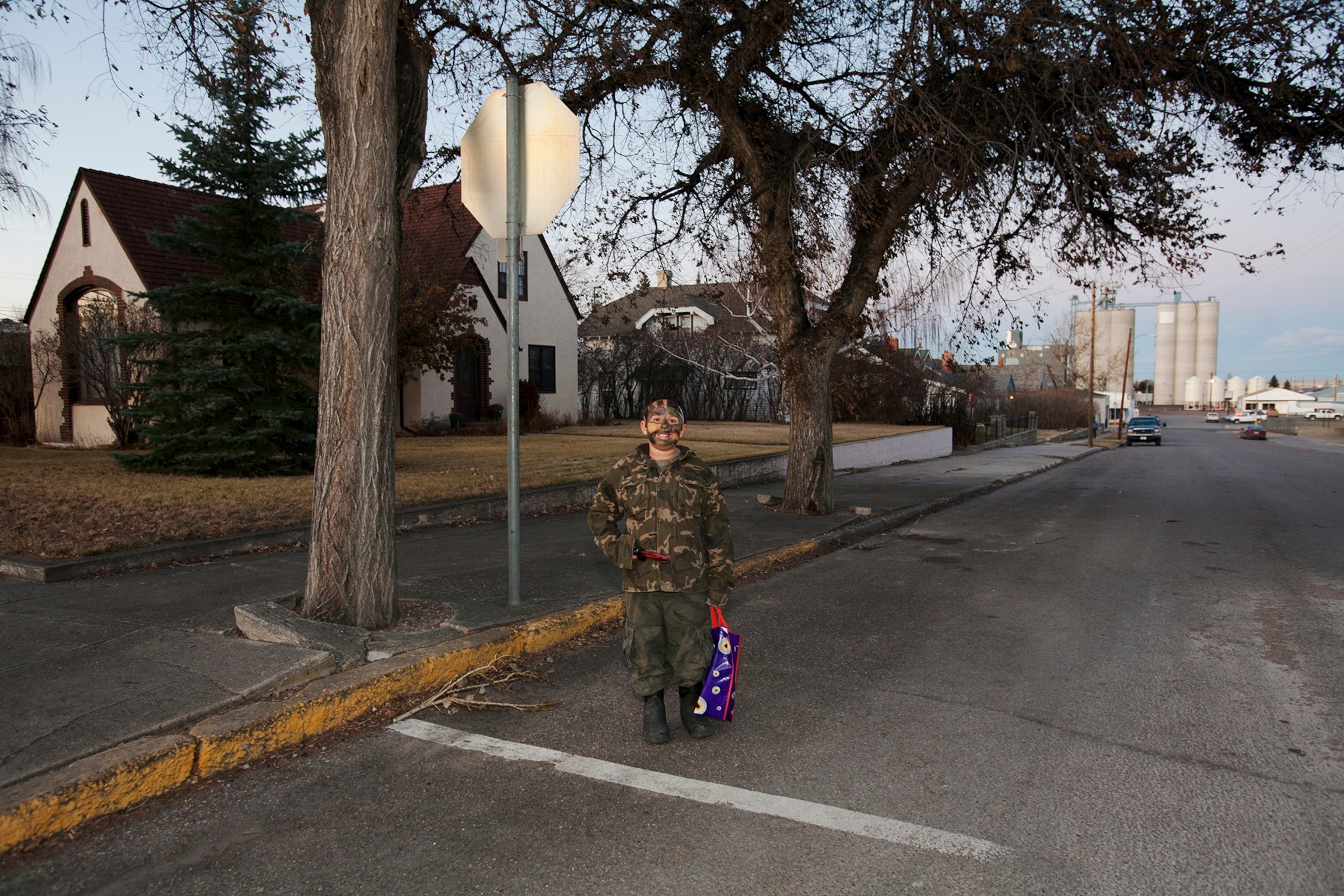 Wearing camouflage, a boy dresses as a soldier on Halloween in Galata, Montana.
