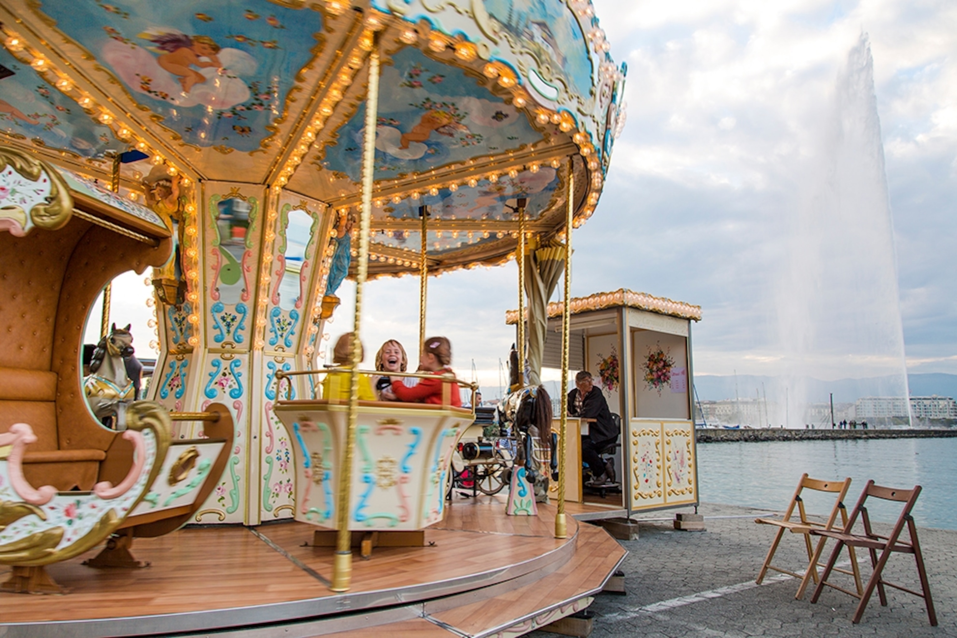 a carousel on the banks of Lake Geneva and the Jet d'Eau, Switzerland