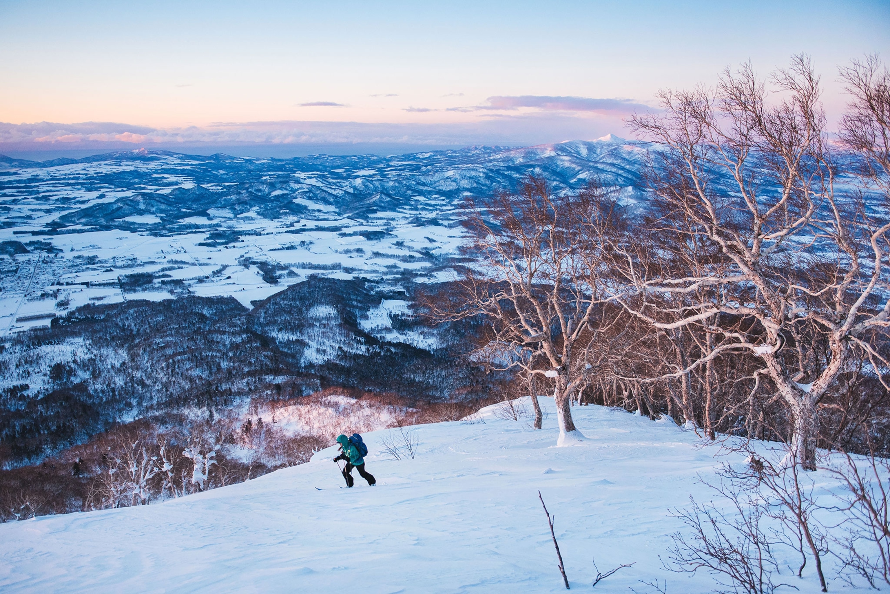A skier skins up at dawn on Mount Yotei in Shikotsu-Toya National Park.