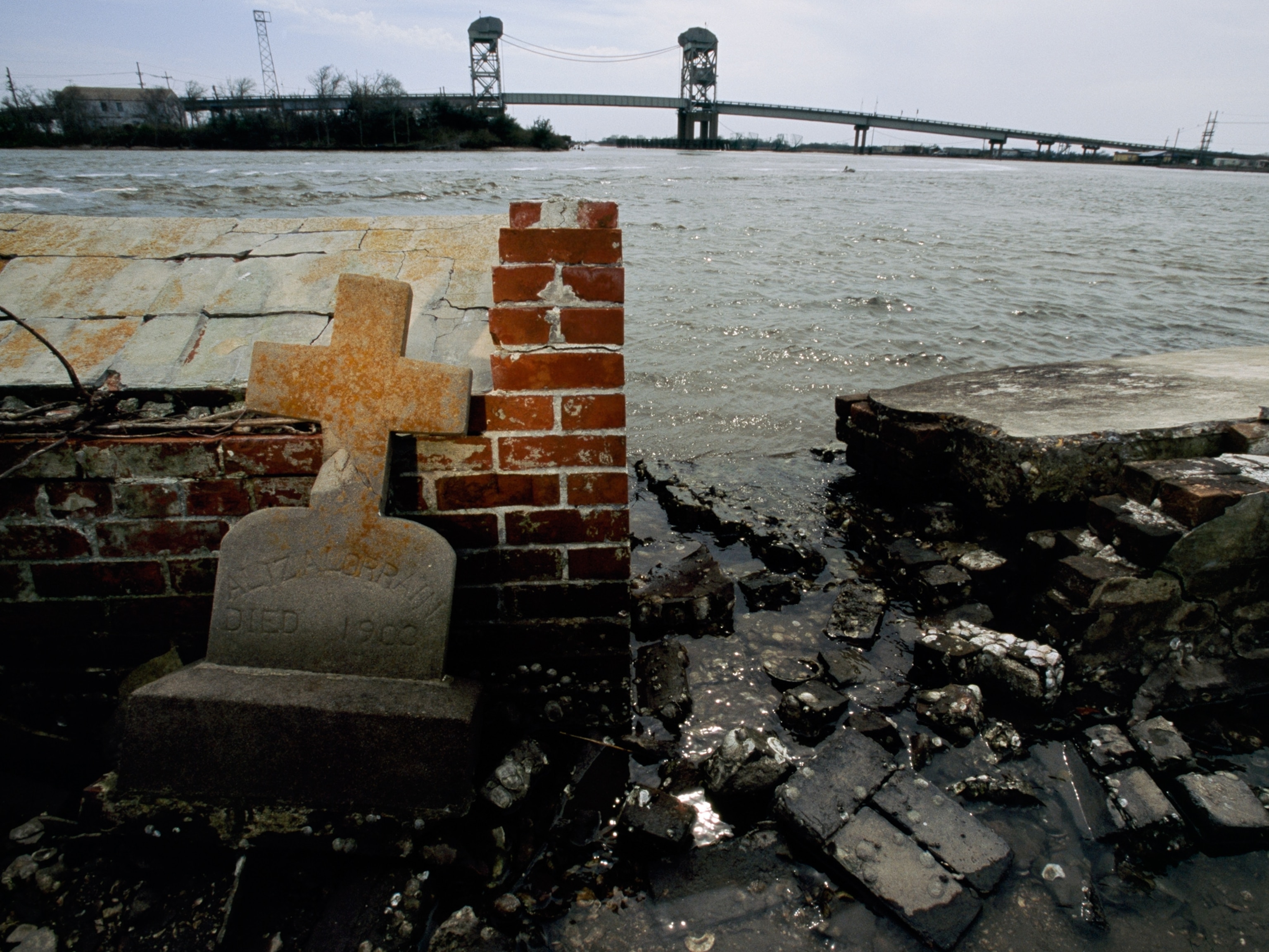 Tombstone over a flooded grave in Leeville, Louisiana.