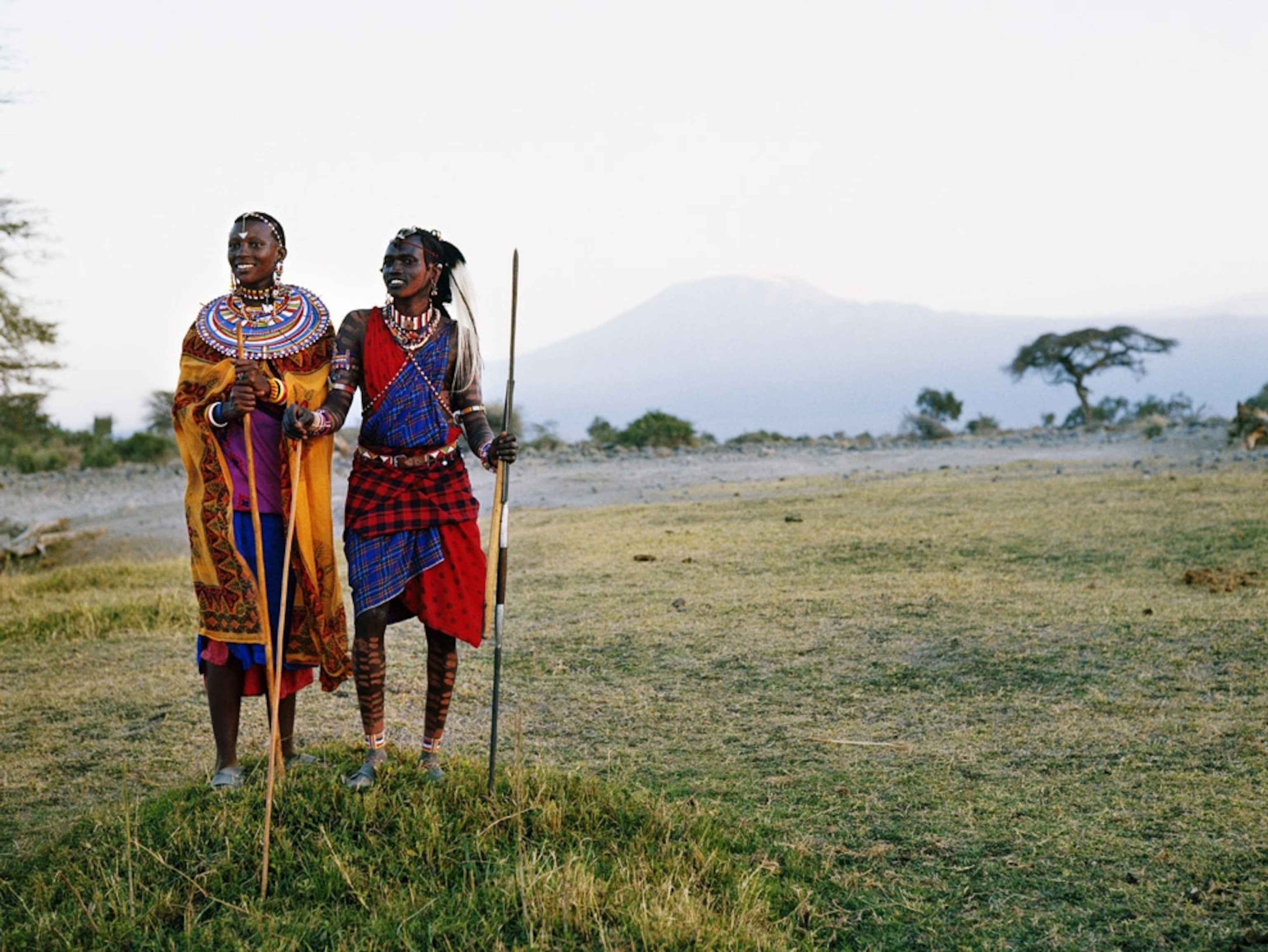 Two tribespeople standing on a plain