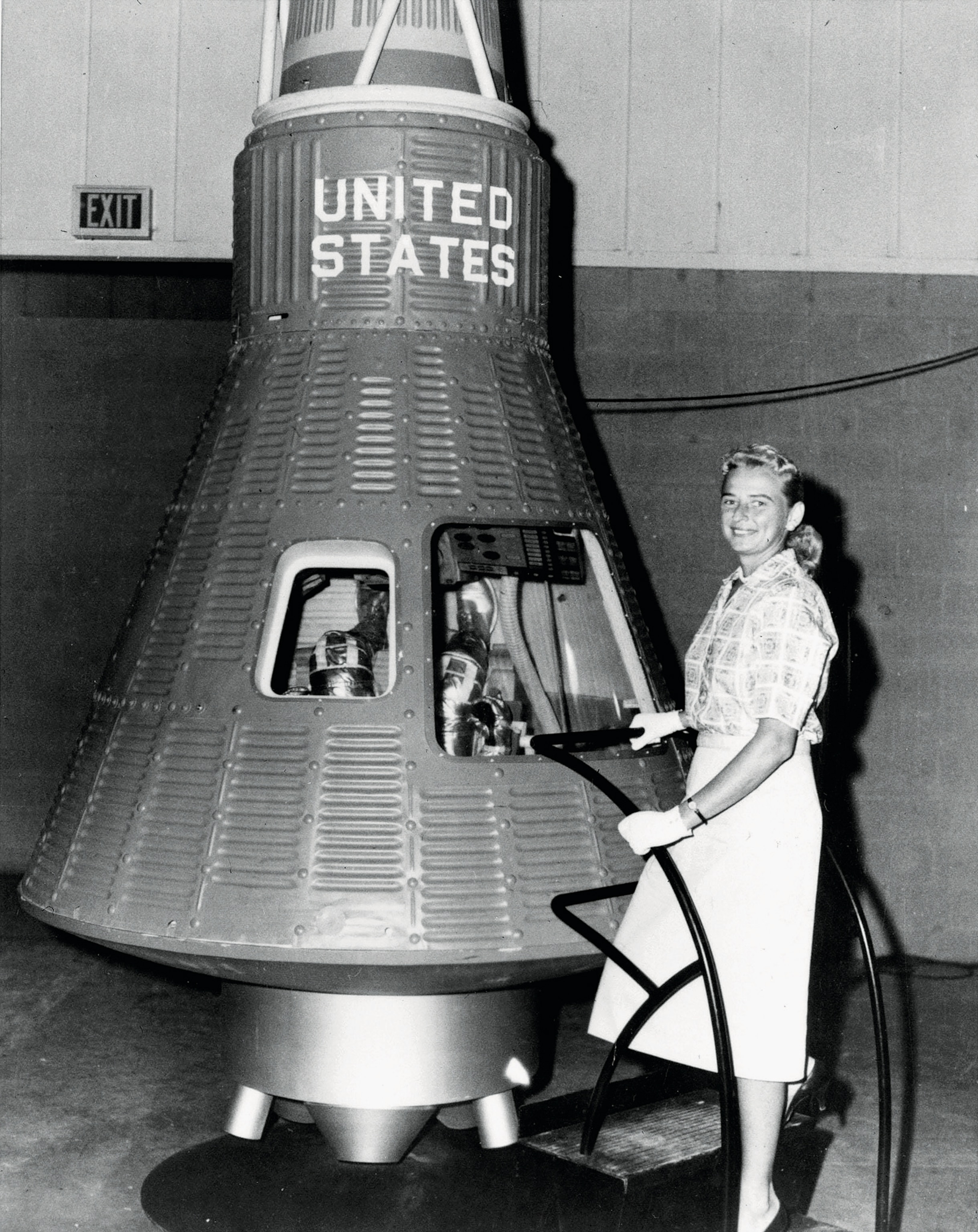 Pilot Jerrie Cobb poses with the Freedom 7 Mercury capsule.