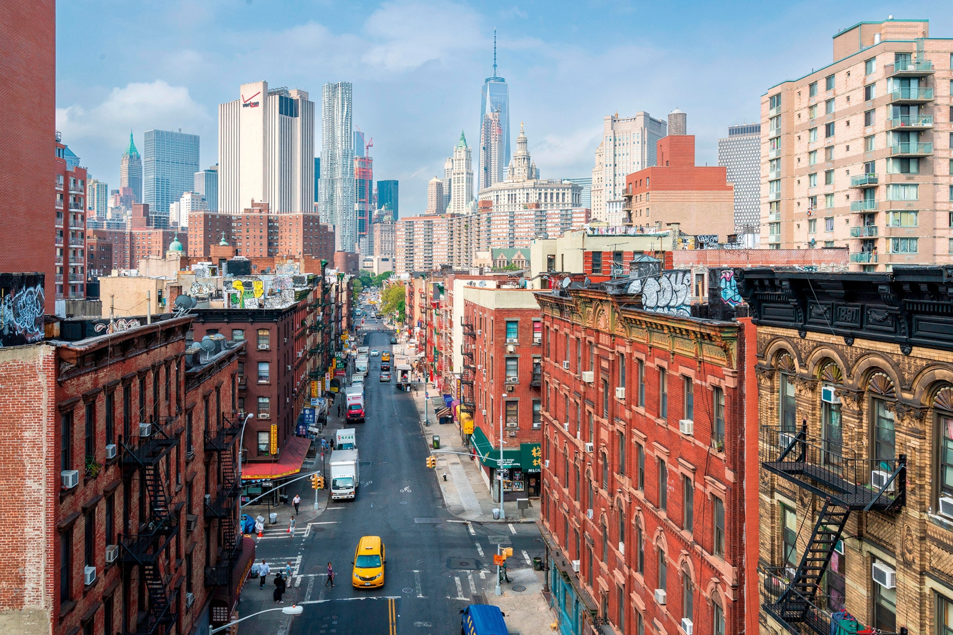 A bird's eye perspective on New York City's Chinatown with skyscrapers in the distance.