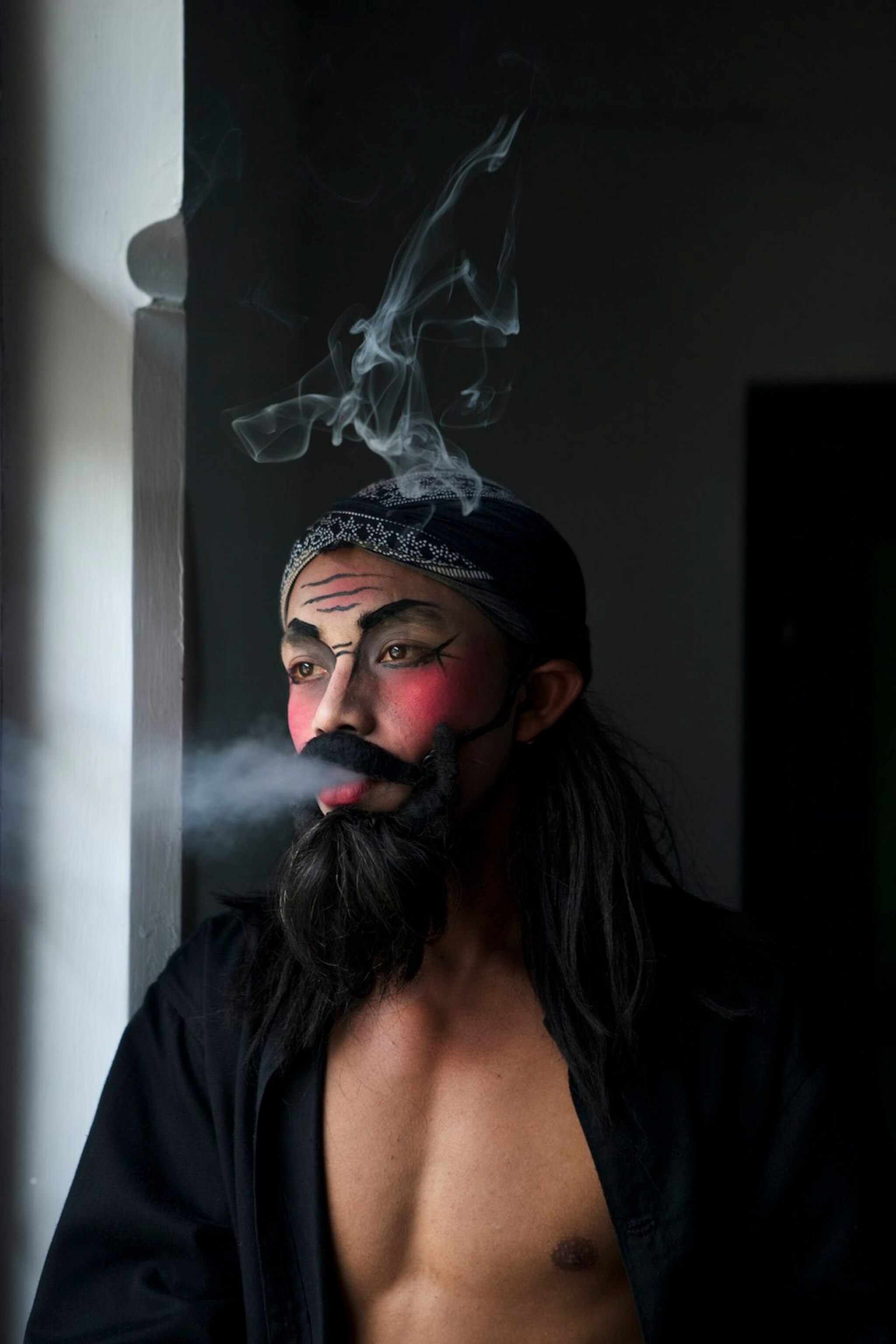 a man wearing traditional face paint in Indonesia