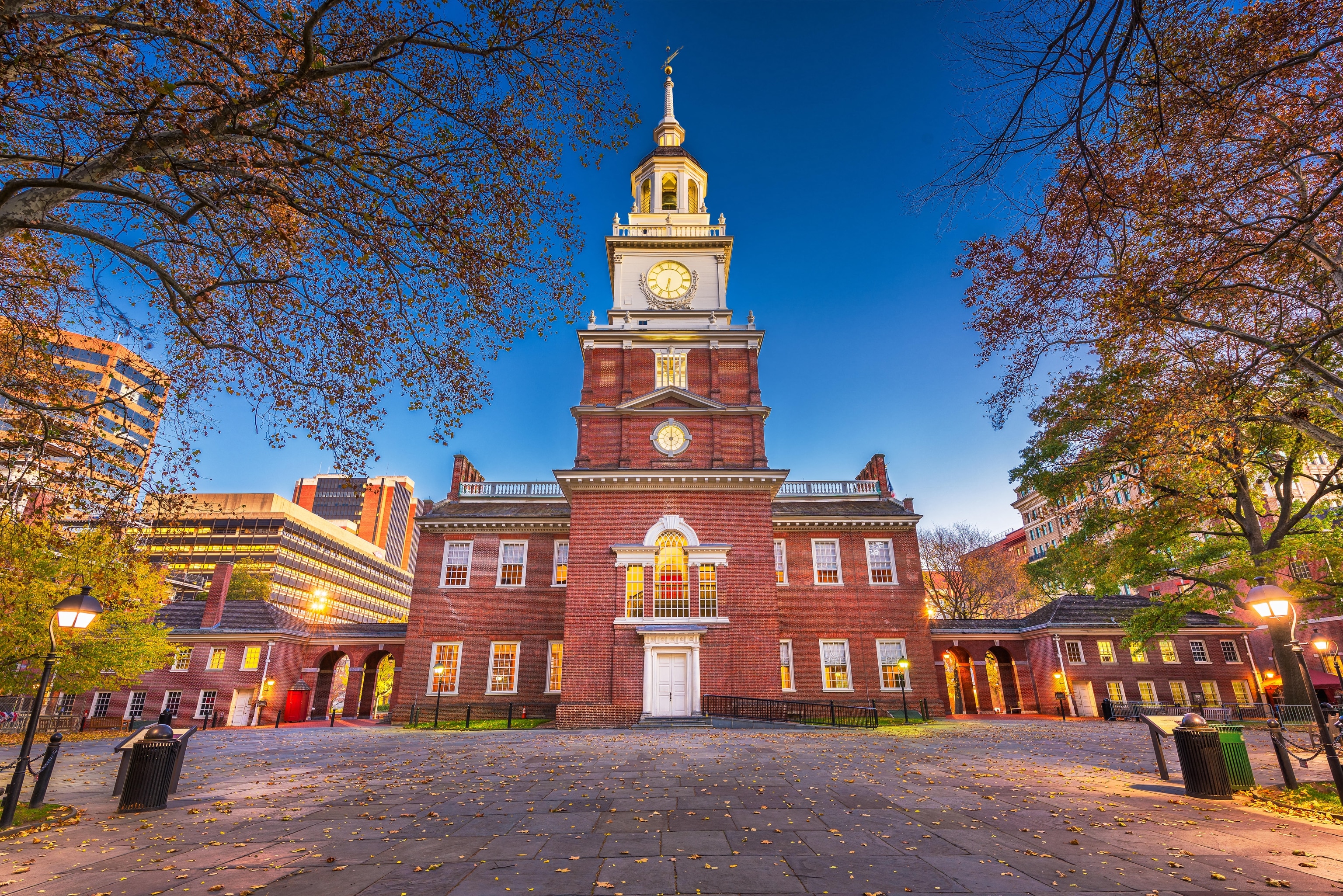 A historic building with red brick and white trim at dusk