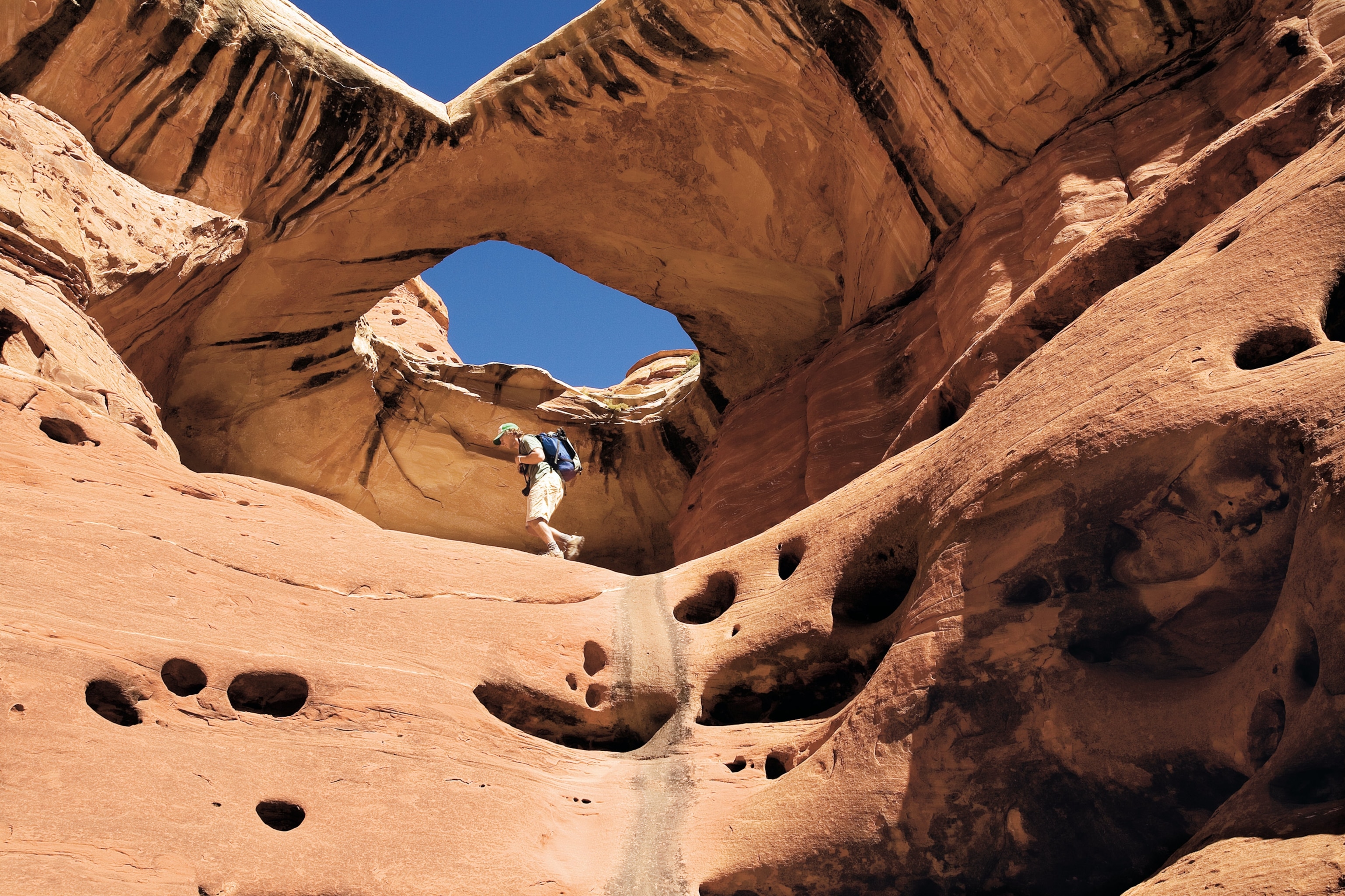 a hiker near Paul Bunyons Potty in the Needles District, Canyonlands National Park
