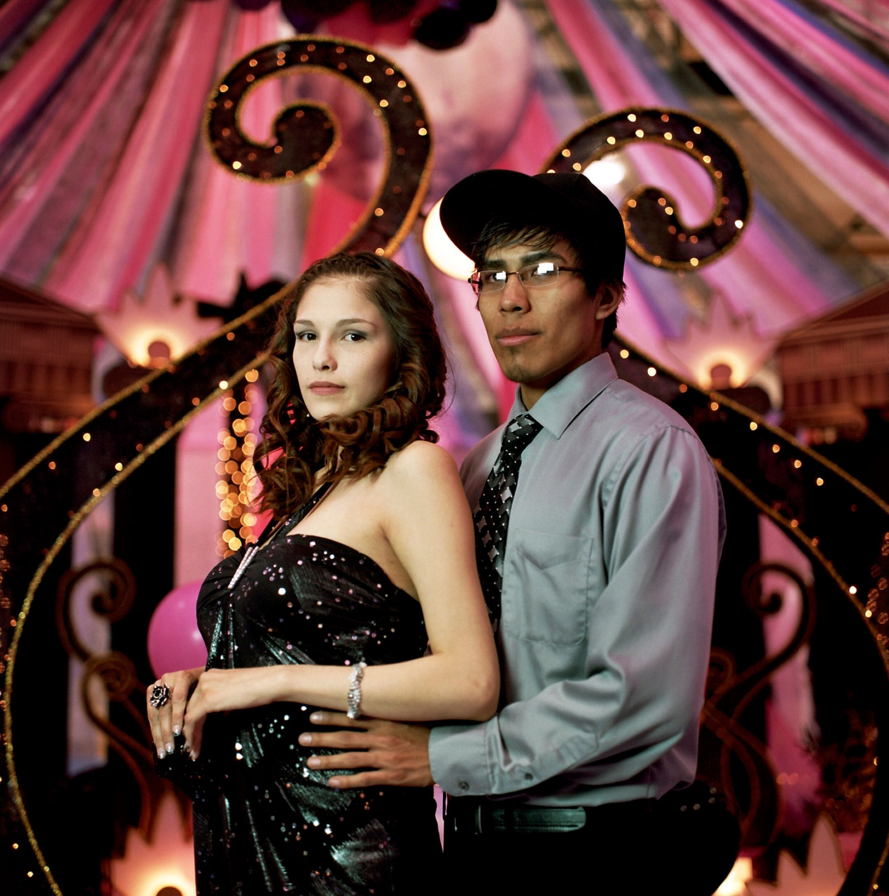 a couple posing for a prom photo
