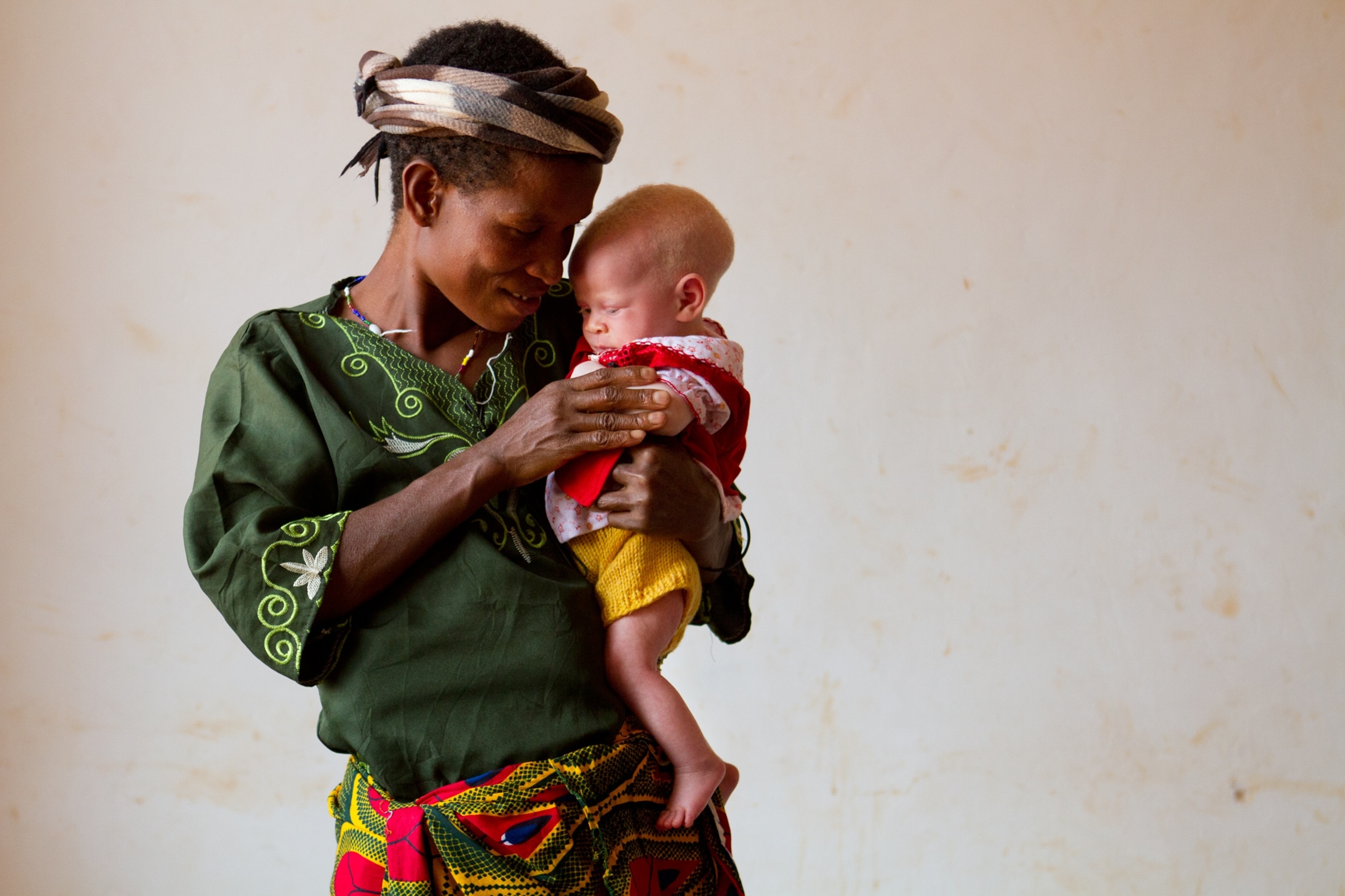 a woman holding her daughter at the Kabanga Protectorate Center, Tanzania