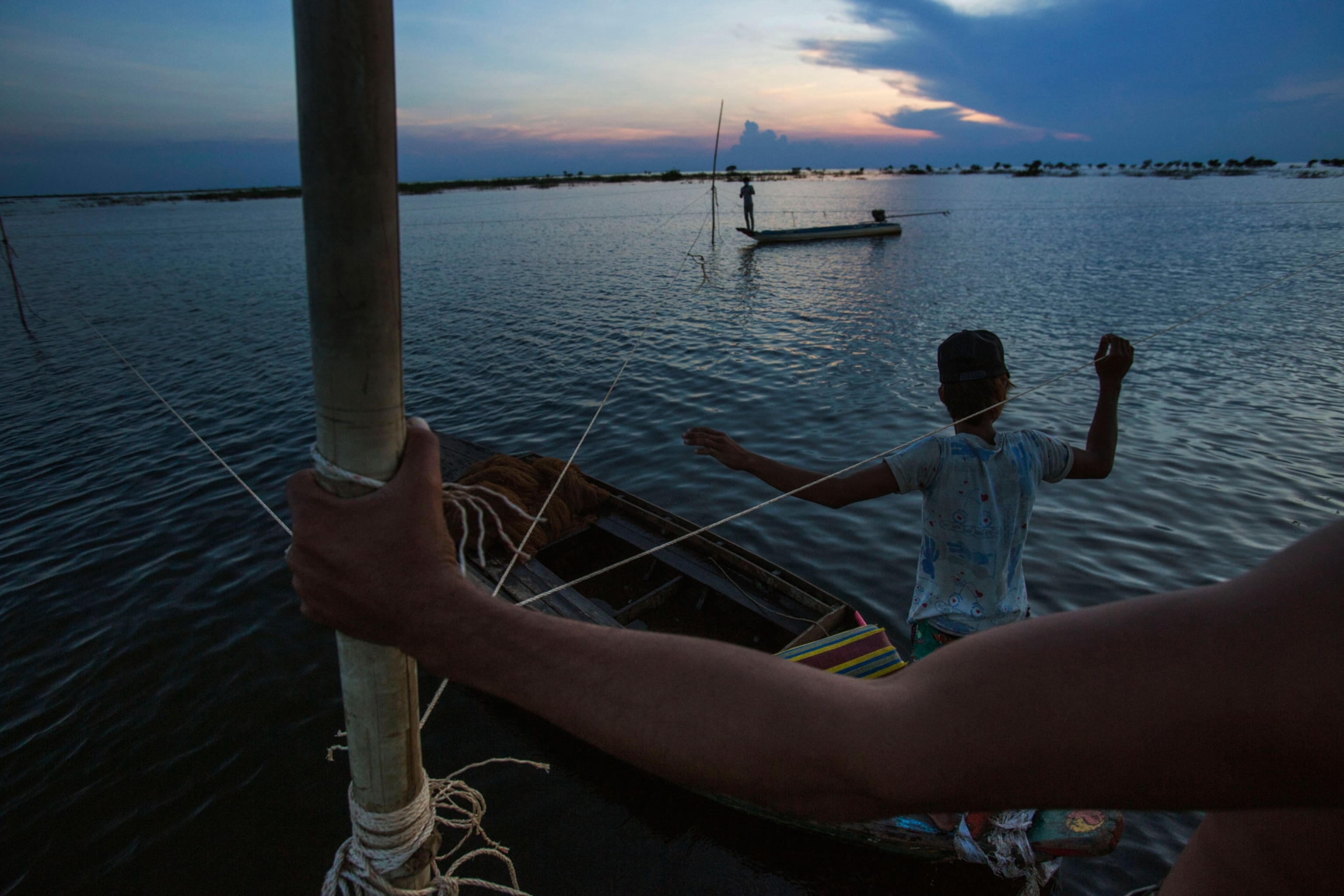 Fishermen place nets in Tonle Sap Lake, Cambodia.