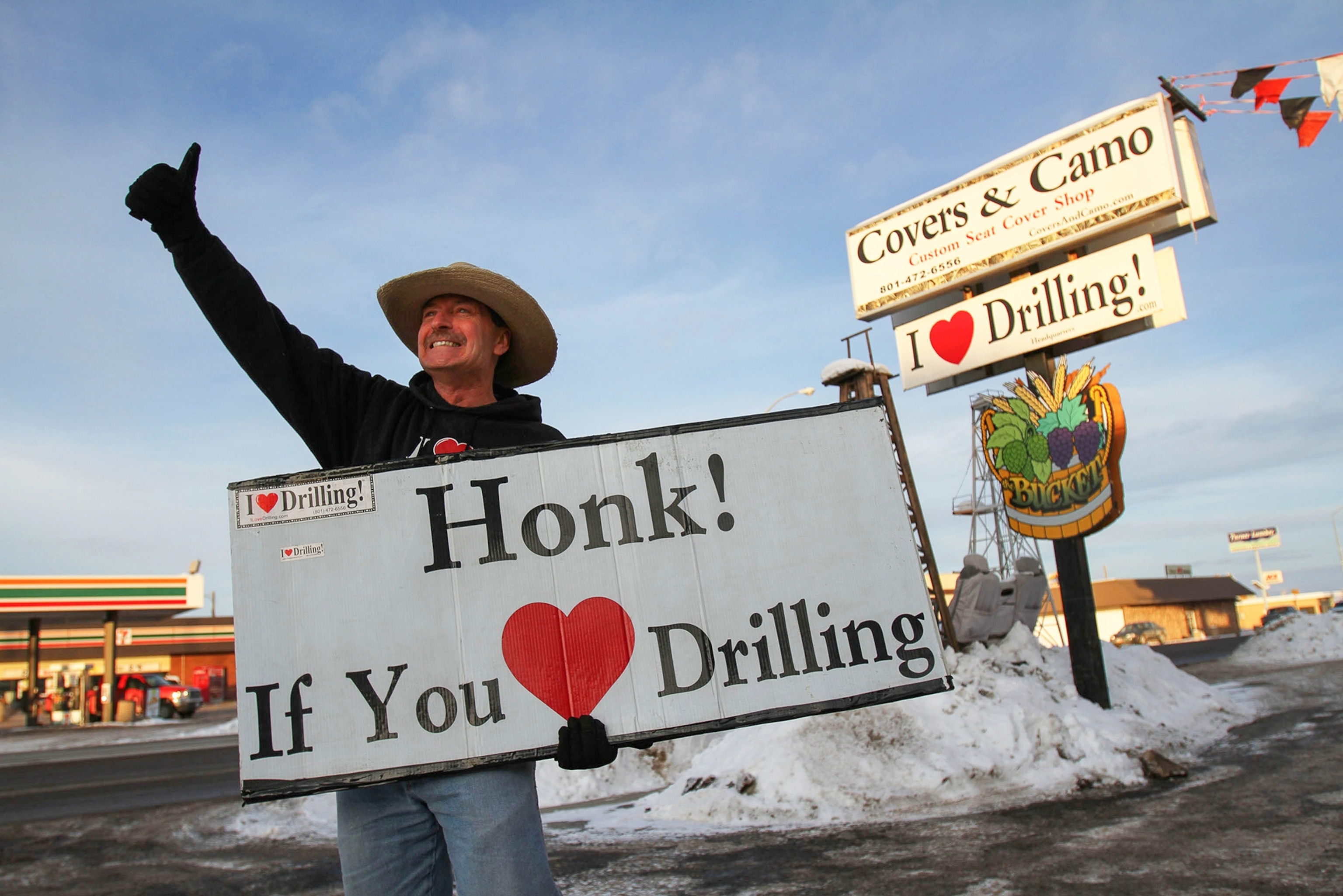 the owner of a store in Utah holding a sign outside of his store