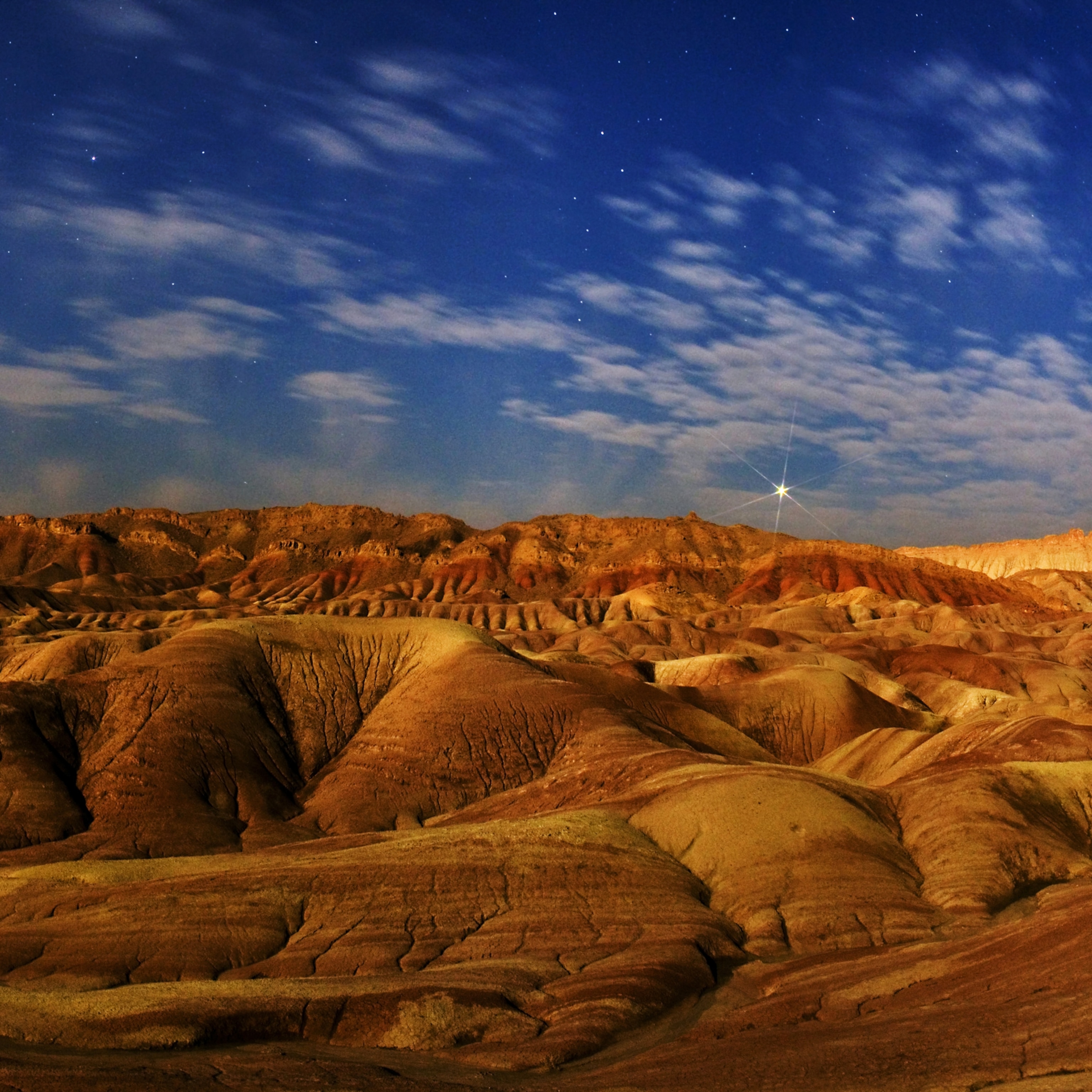 Moonlight illuminates colorful salt domes in Dasht-e Kavir. Planet Venus shines at the horizon. –