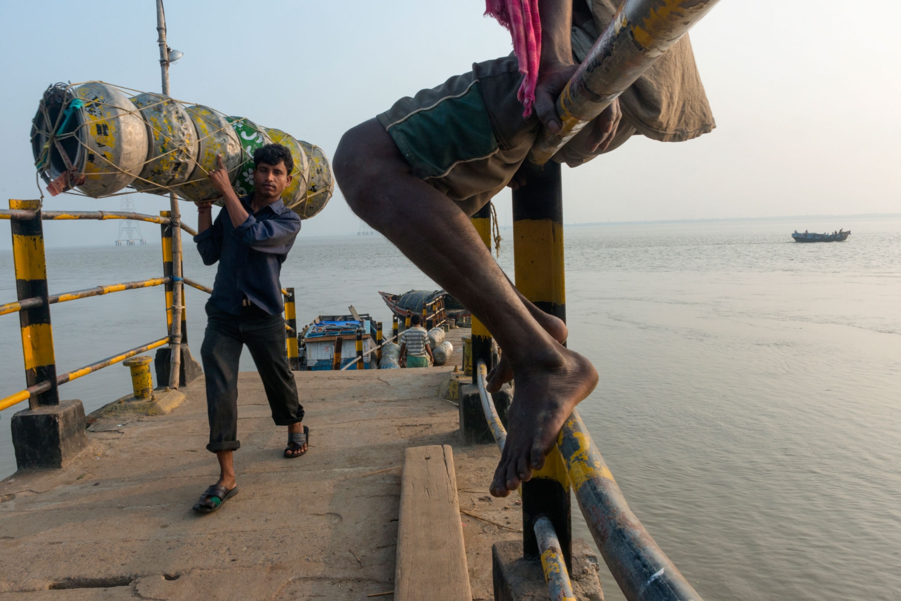 men on a dock on Sagar Island, India