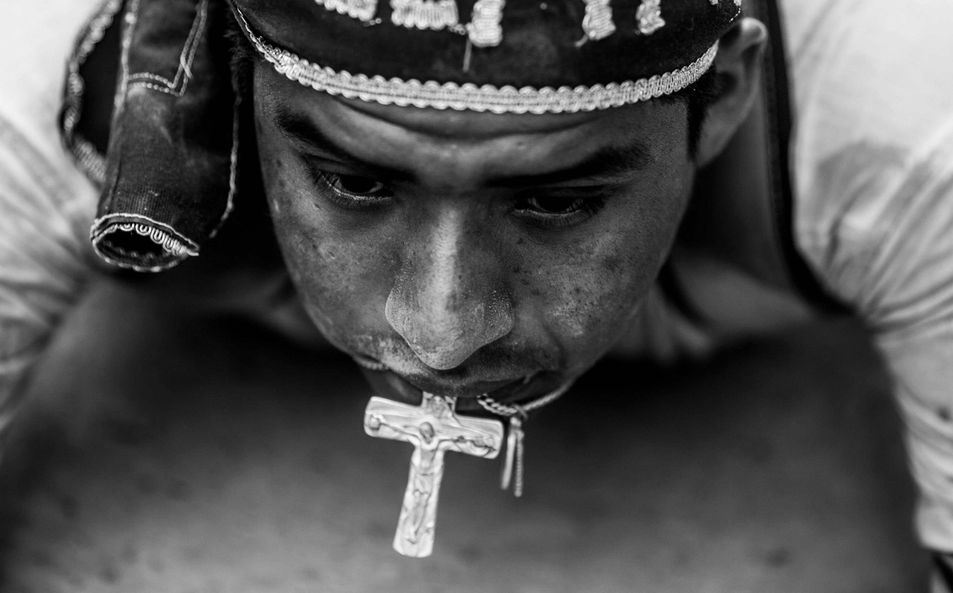 man with cross in mouth