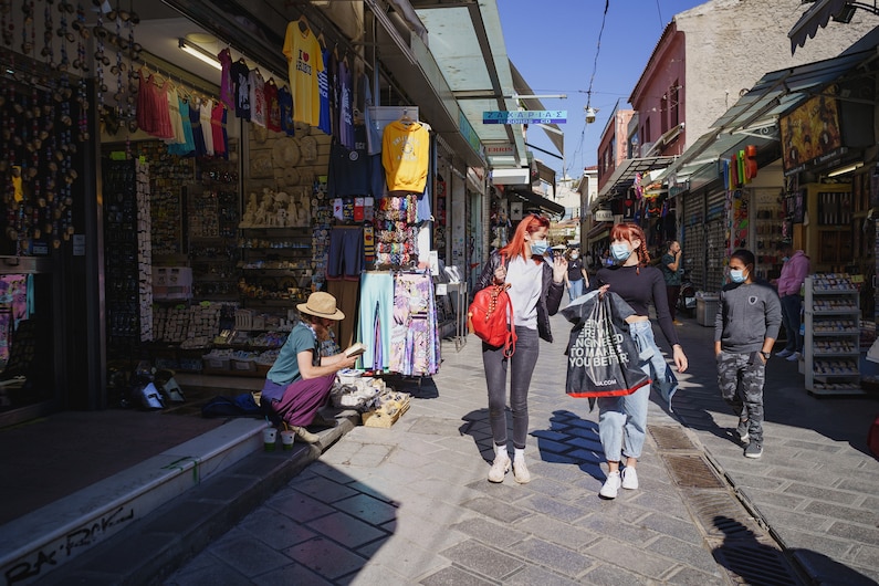 people walking through the tourist district in Athens, Greece