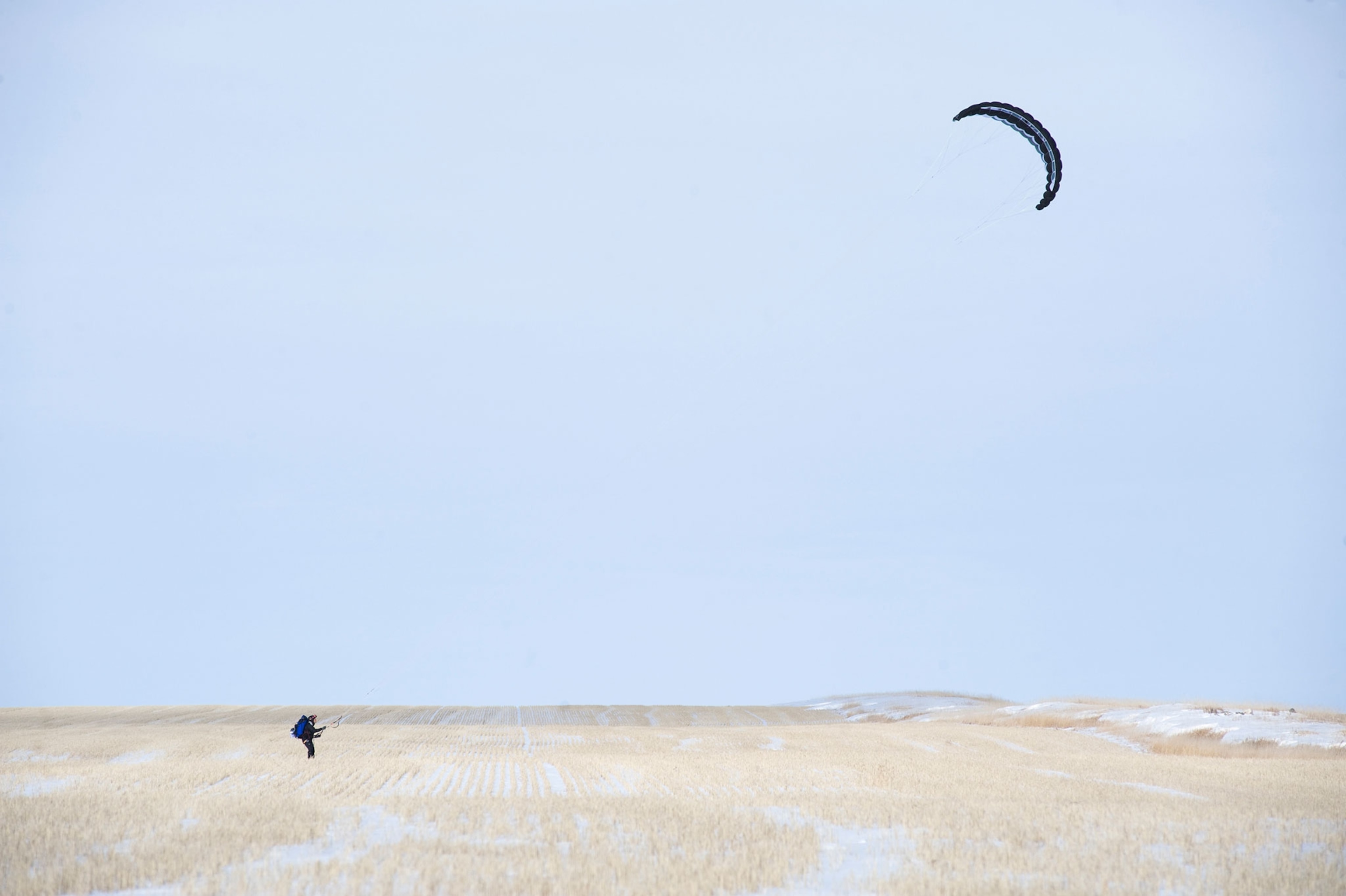 a man riding a snowkite across a field in North Dakota