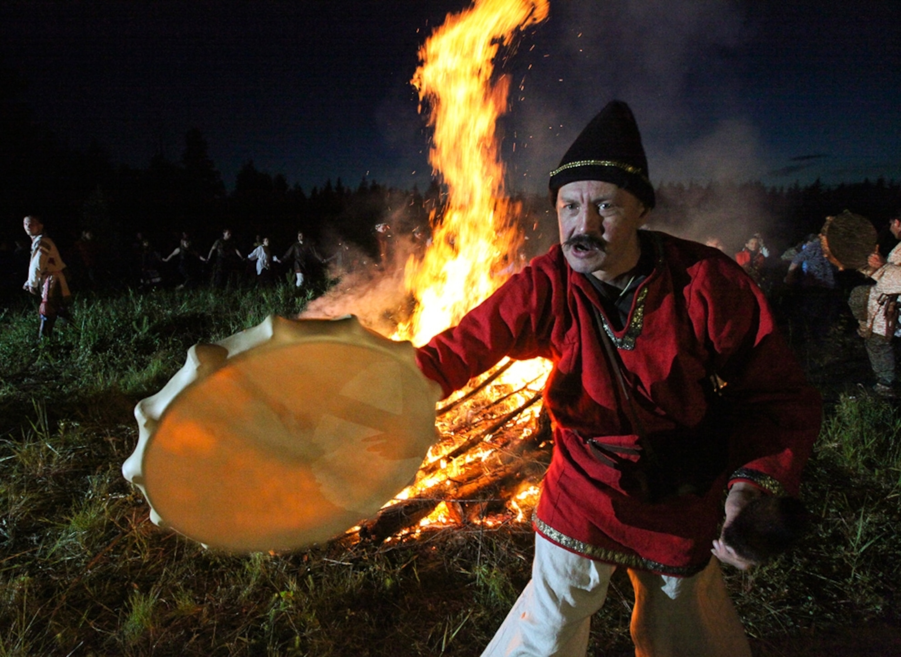 pagans dancing near a fire to celebrate summer solstice 2010.