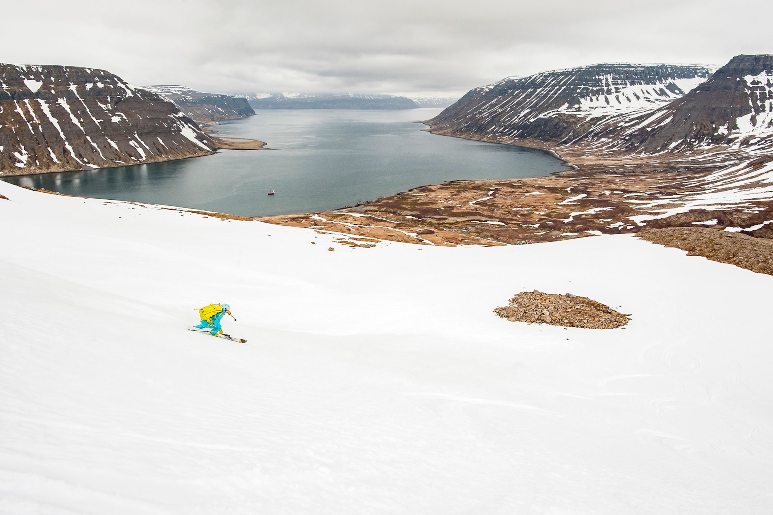 skier skiing down to a fjord in Iceland