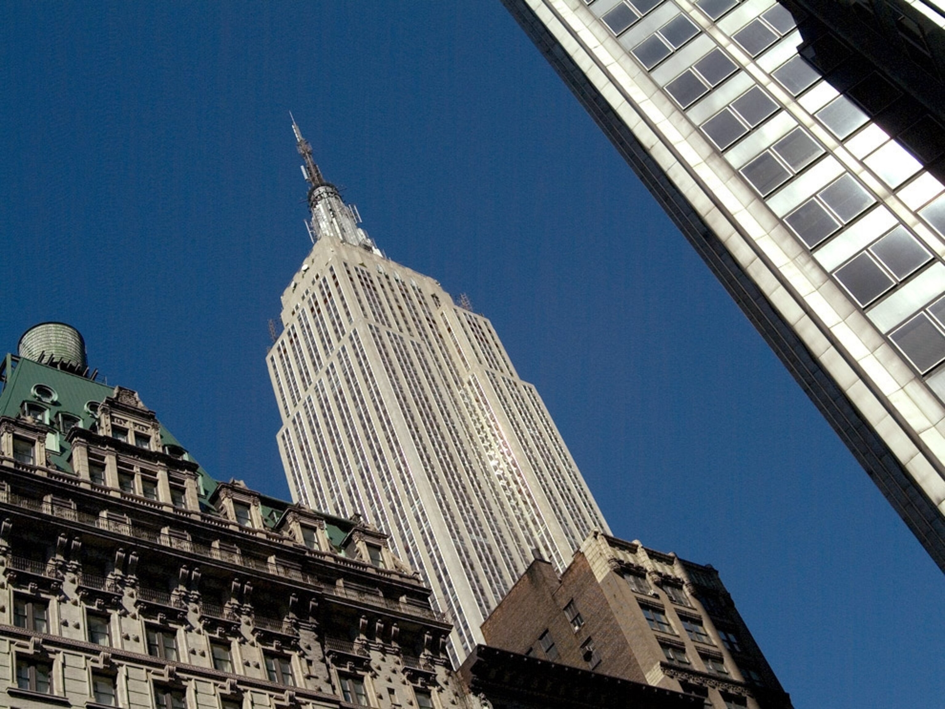 Angled view of New York's Empire State Building against a blue sky