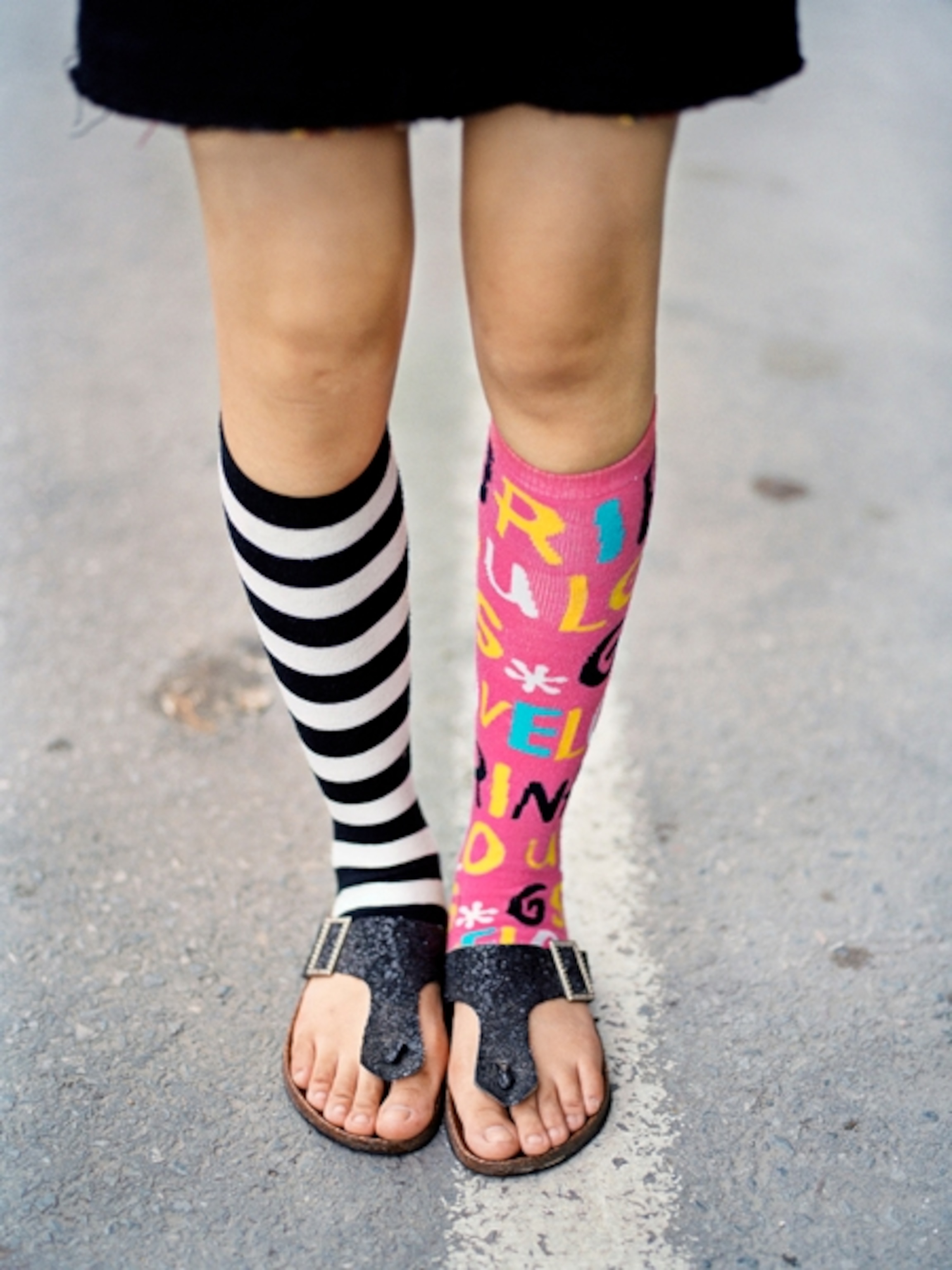 Legs with bright, mismatched socks