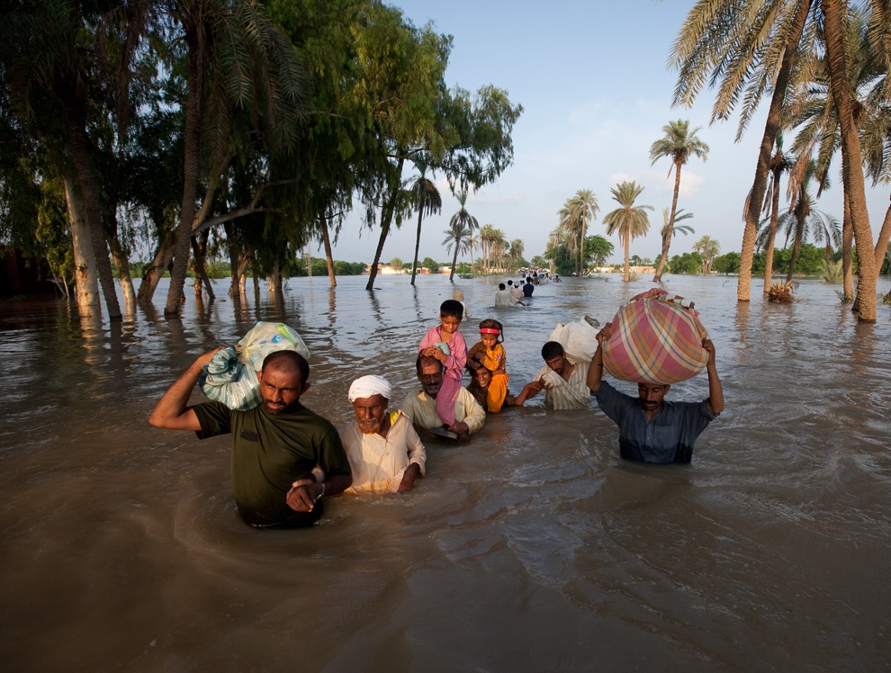 A family wades through flood waters in Pakistan.