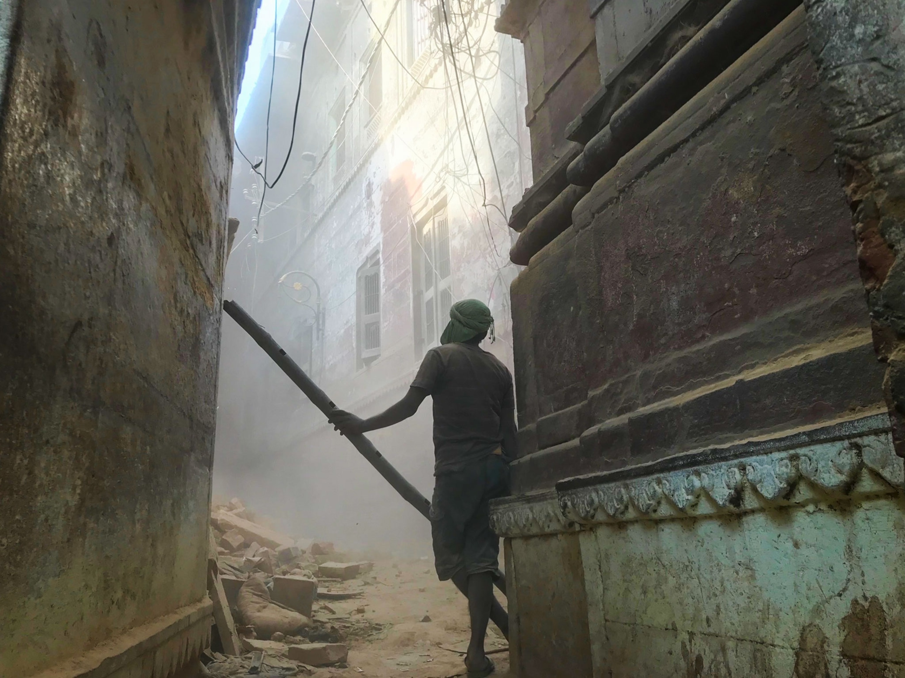 workers demolishing buildings in India